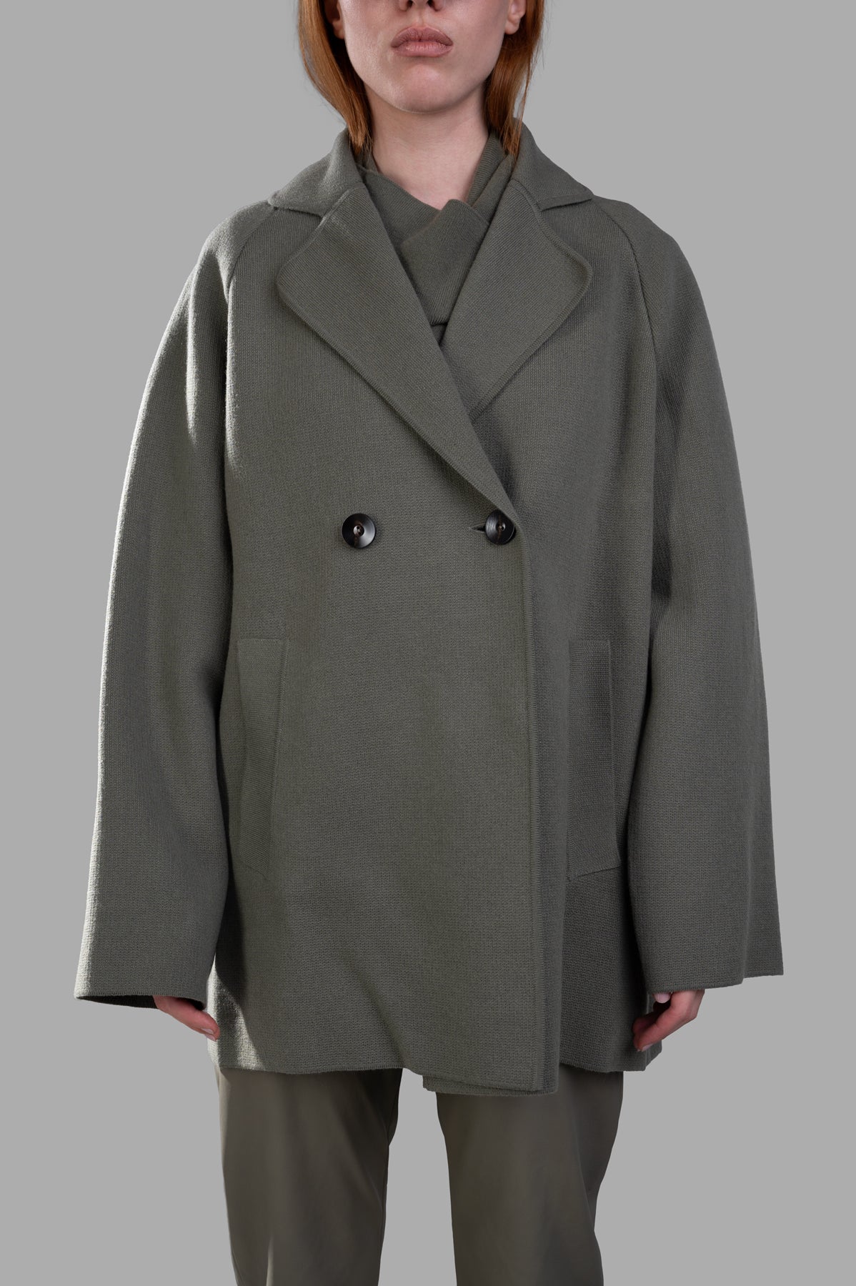 Gentry Portofino Olive Double-breasted Coat in green, showcasing oversized fit, wide lapels, and side pockets on a model.