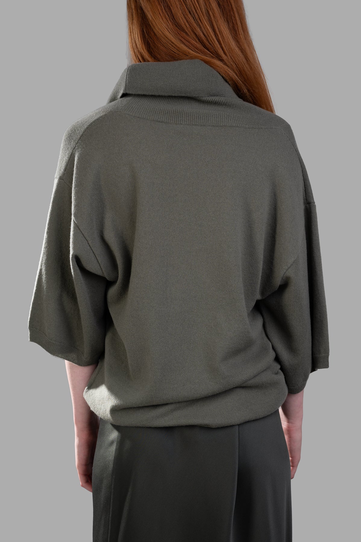 Gentry Portofino Olive Sweater featuring a slouchy fit and shawl neckline, shown from the back with 3/4 sleeves.