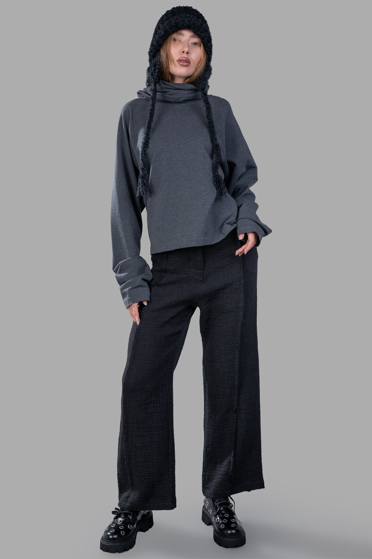 Norma Kamali Raglan-Sleeve Turtleneck Top, grey, on model with hood, oversized fit and long sleeves, chic casual style.