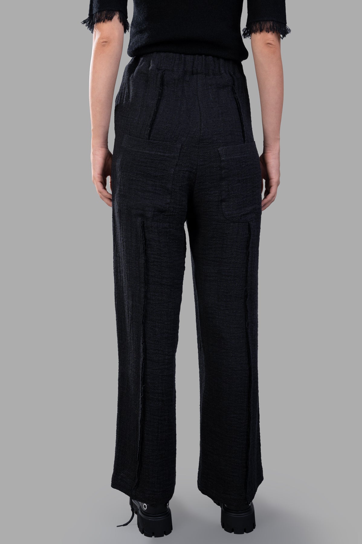 Marc Point Textured Trousers in black, showcasing back view with pleats and wide legs, made from linen-cotton blend.