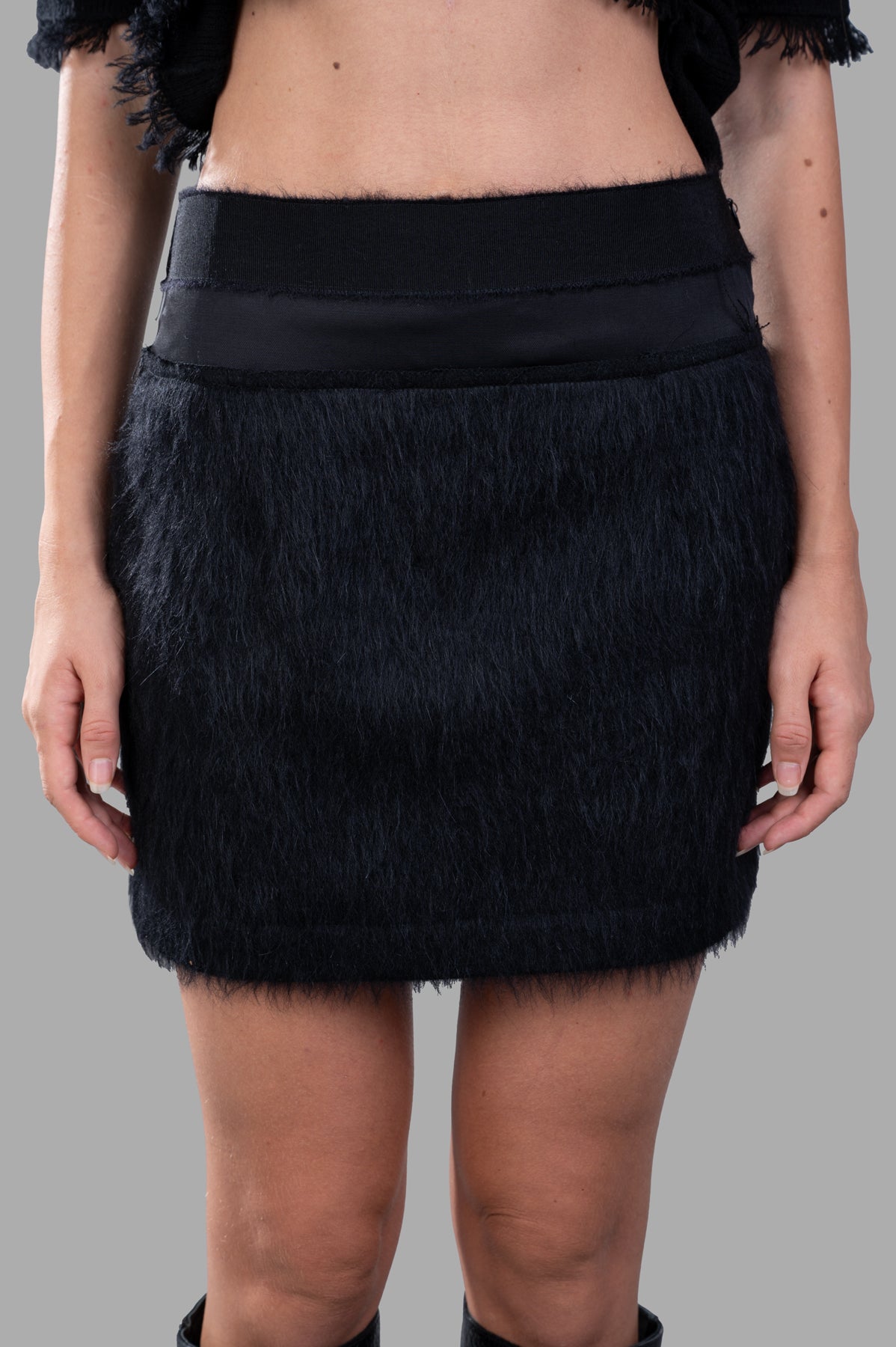 Giovanni Cavagna Mini Furry Skirt, black, high-waisted with plush texture, shown on model from the front, highlighting.