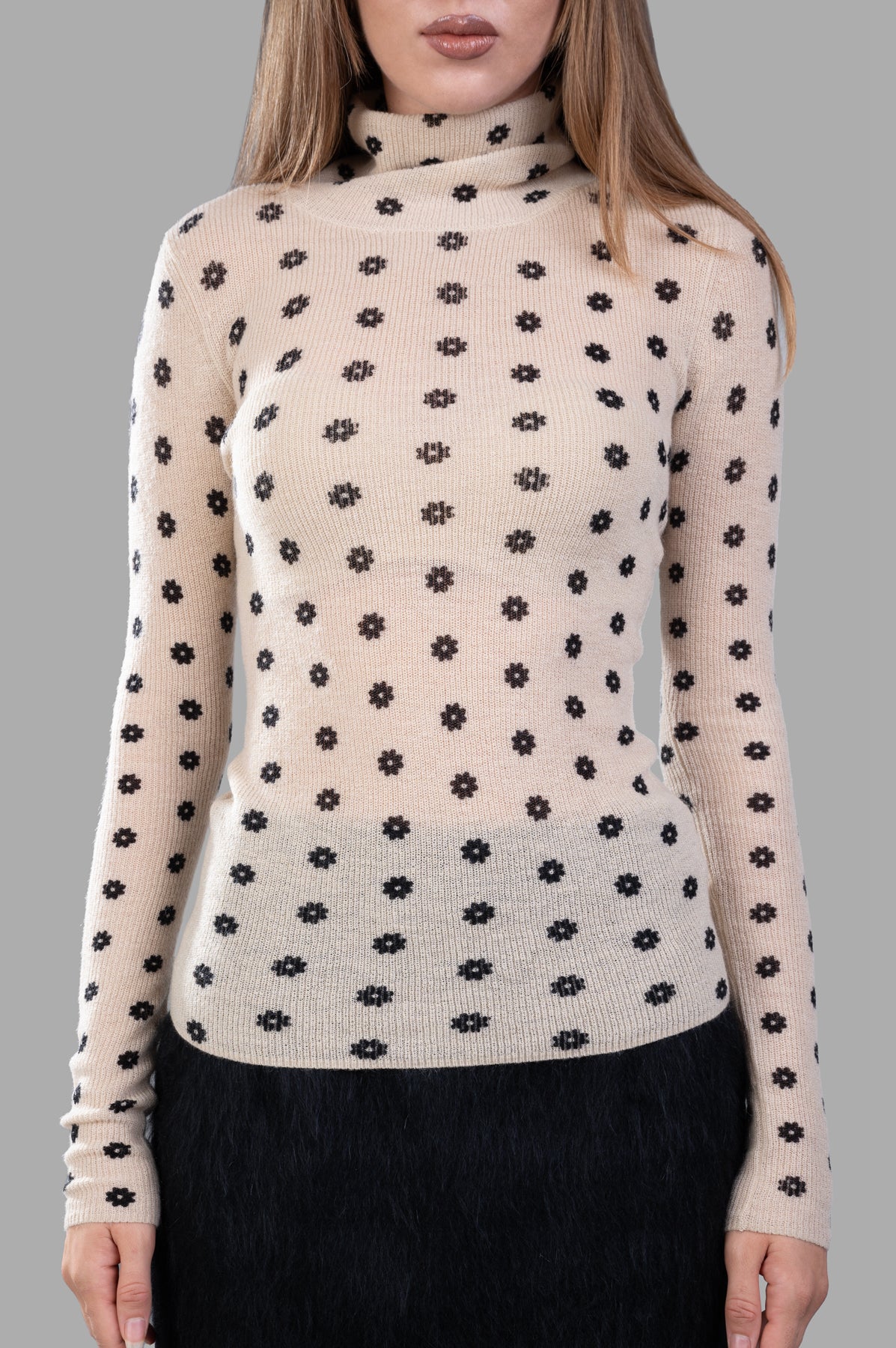 By Malene Birger Fioria Turtleneck Sweater features a fitted design with a beige flower-motif pattern, showcasing soft wool texture.