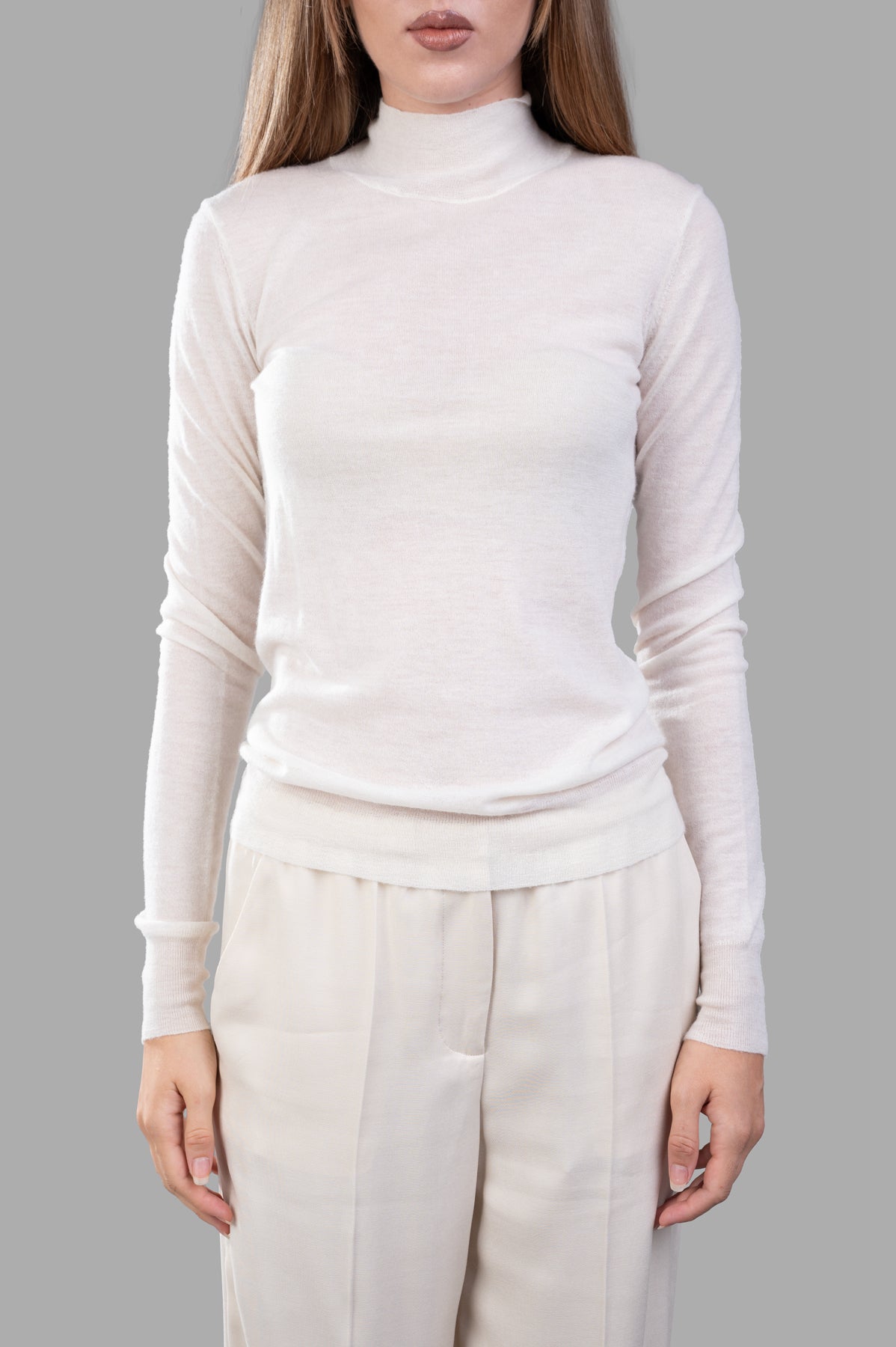 Joseph Cashair High-neck Jumper worn on a model, showcasing the soft fabric and fitted style in a light color.