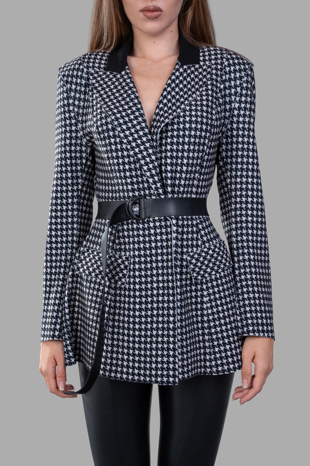 Norma Kamali Single Breasted Riding Jacket with flared fit, contrast collar, and belted waist, showcasing elegant detailing.