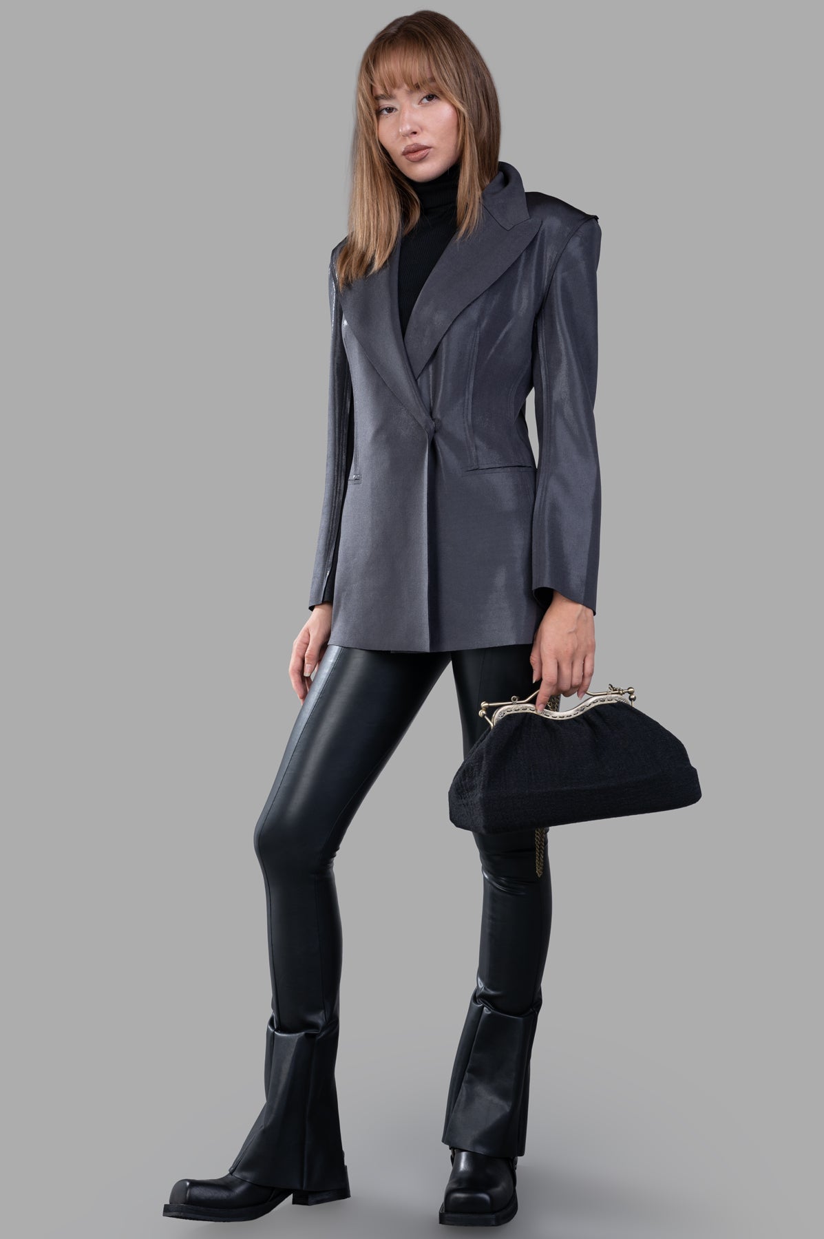 Norma Kamali Fitted Double-Breasted Jacket in silver on model, showcasing slim fit, wide lapel, and shoulder pads.