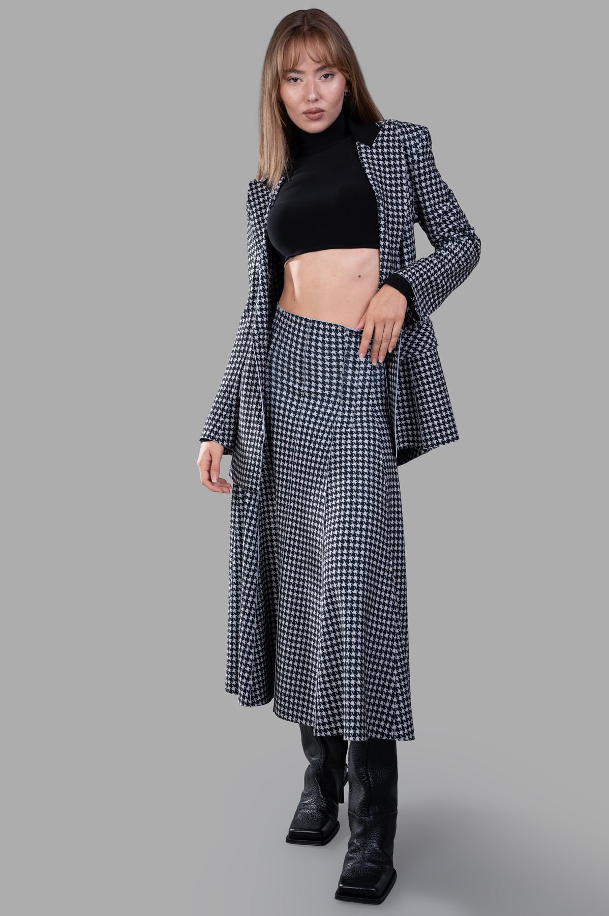 Norma Kamali Grace Houndstooth Skirt, front view on model, black/white, high waist, elegant A-line style.