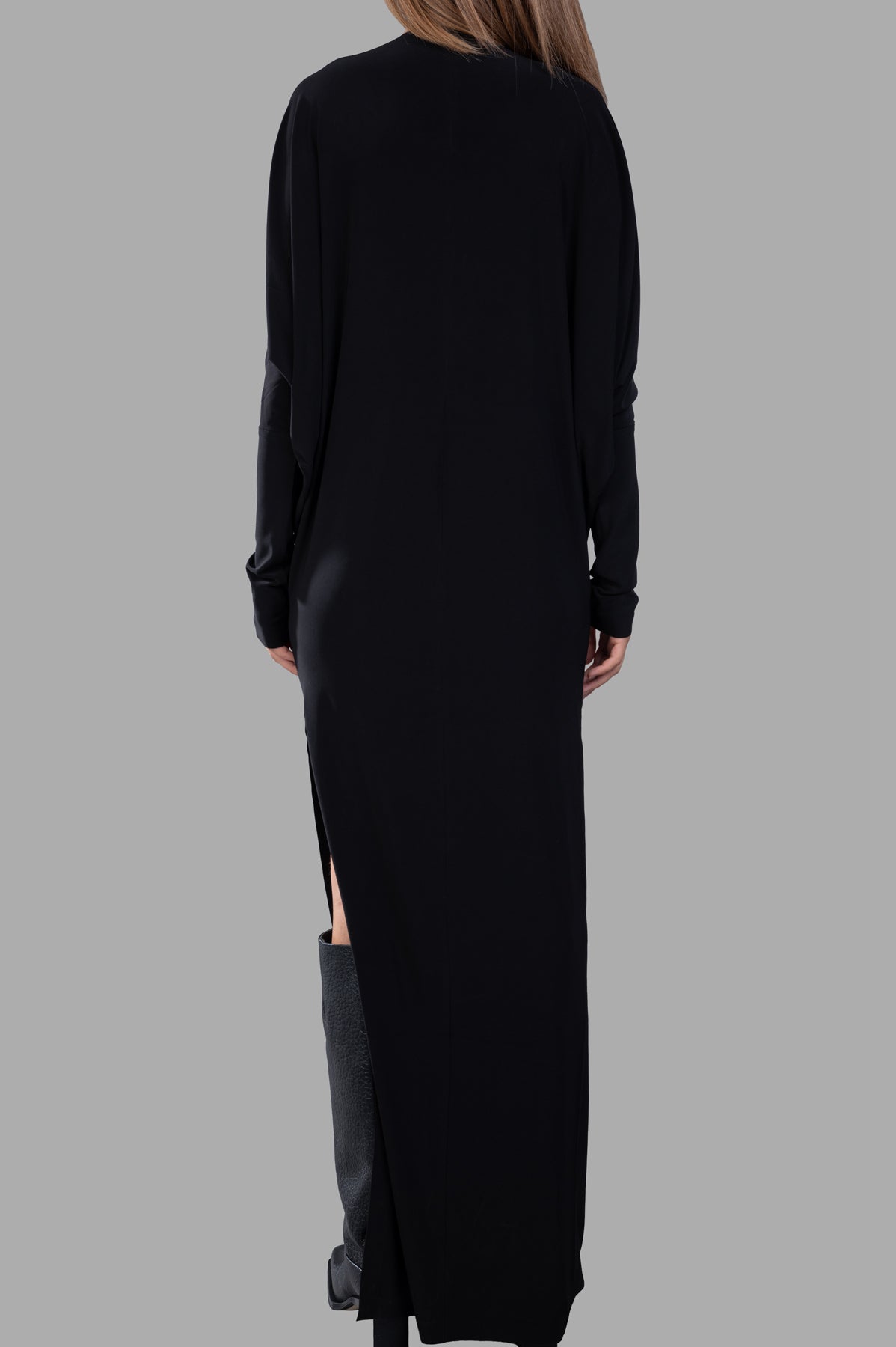 Norma Kamali Dolman Wrap Gown in black, showcasing the back view with a side slit and elegant draped silhouette.