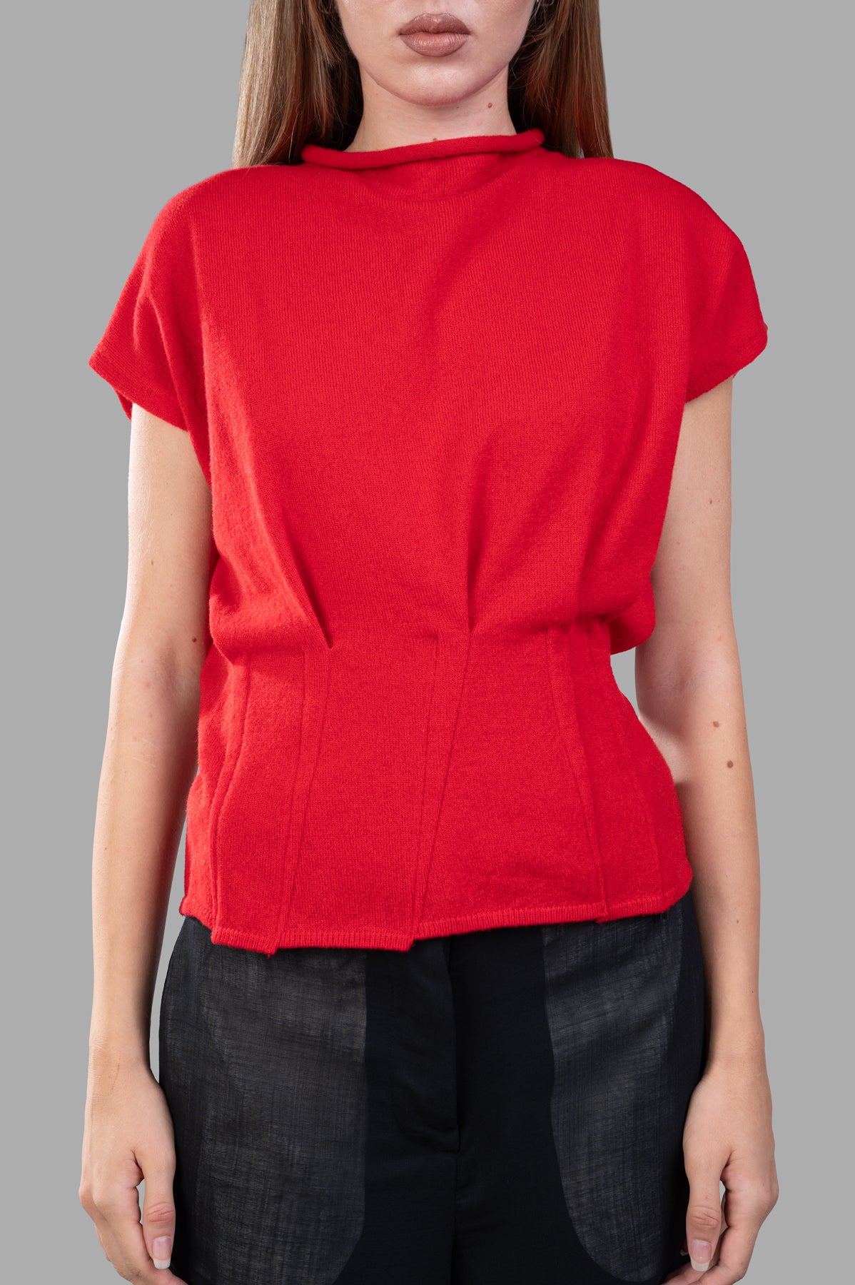 Giovanni Cavagna Fitted Sweater Vest in red, showcasing cap sleeves and tailored waist on model, luxurious wool-cashmere blend.