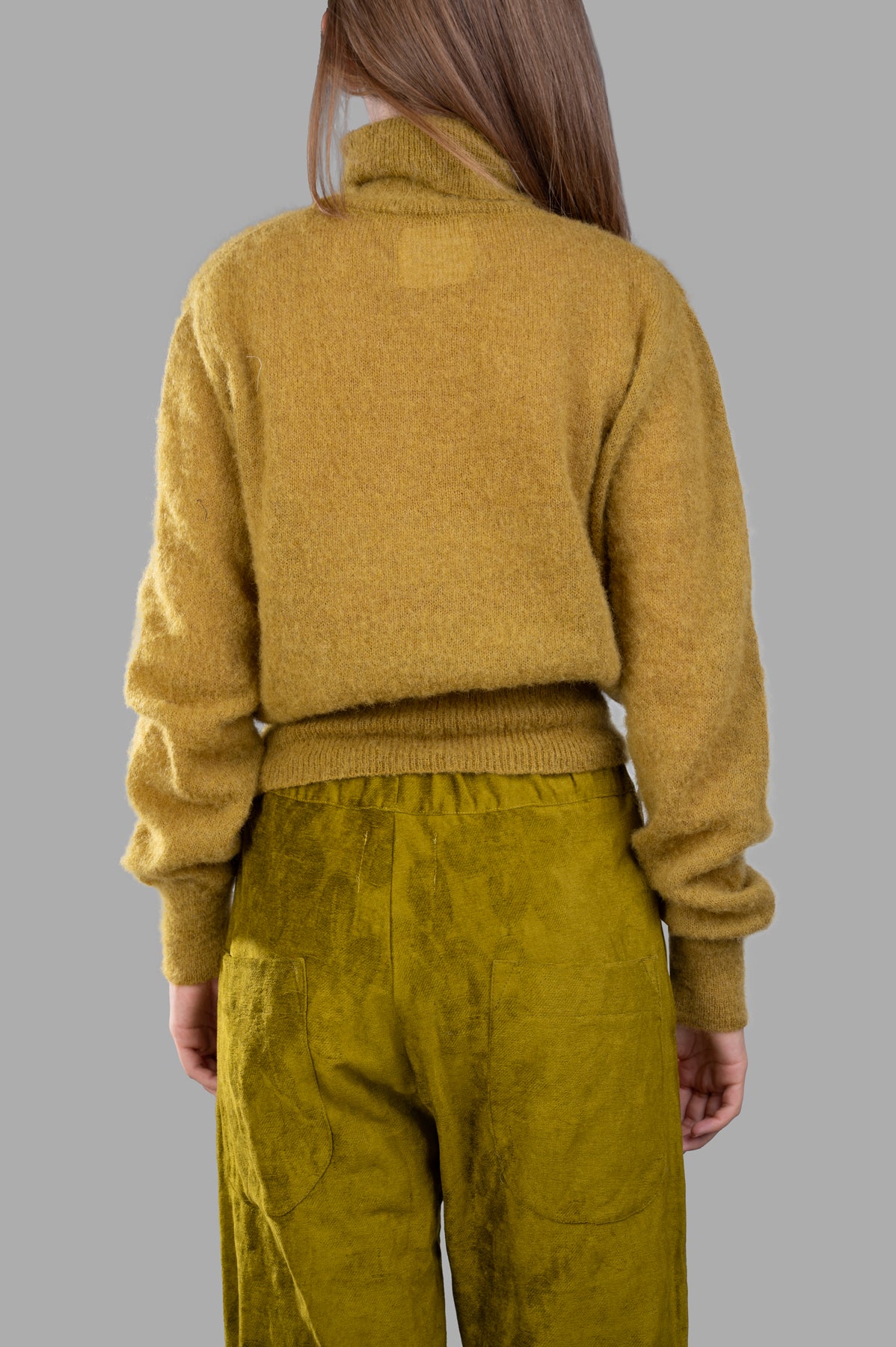 Marc Point Turtleneck Sweater in cozy ochre, featuring a soft back view with ribbed hem and sleeves. Perfect for winter.