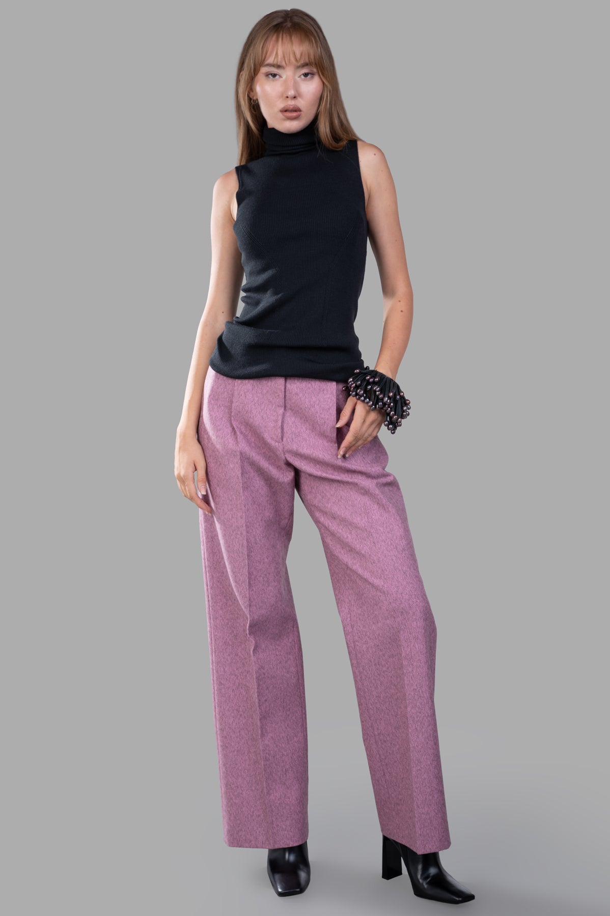 MSGM Melange Trousers in pink with a straight leg, masculine cut, shown on-model with a black top and boots.