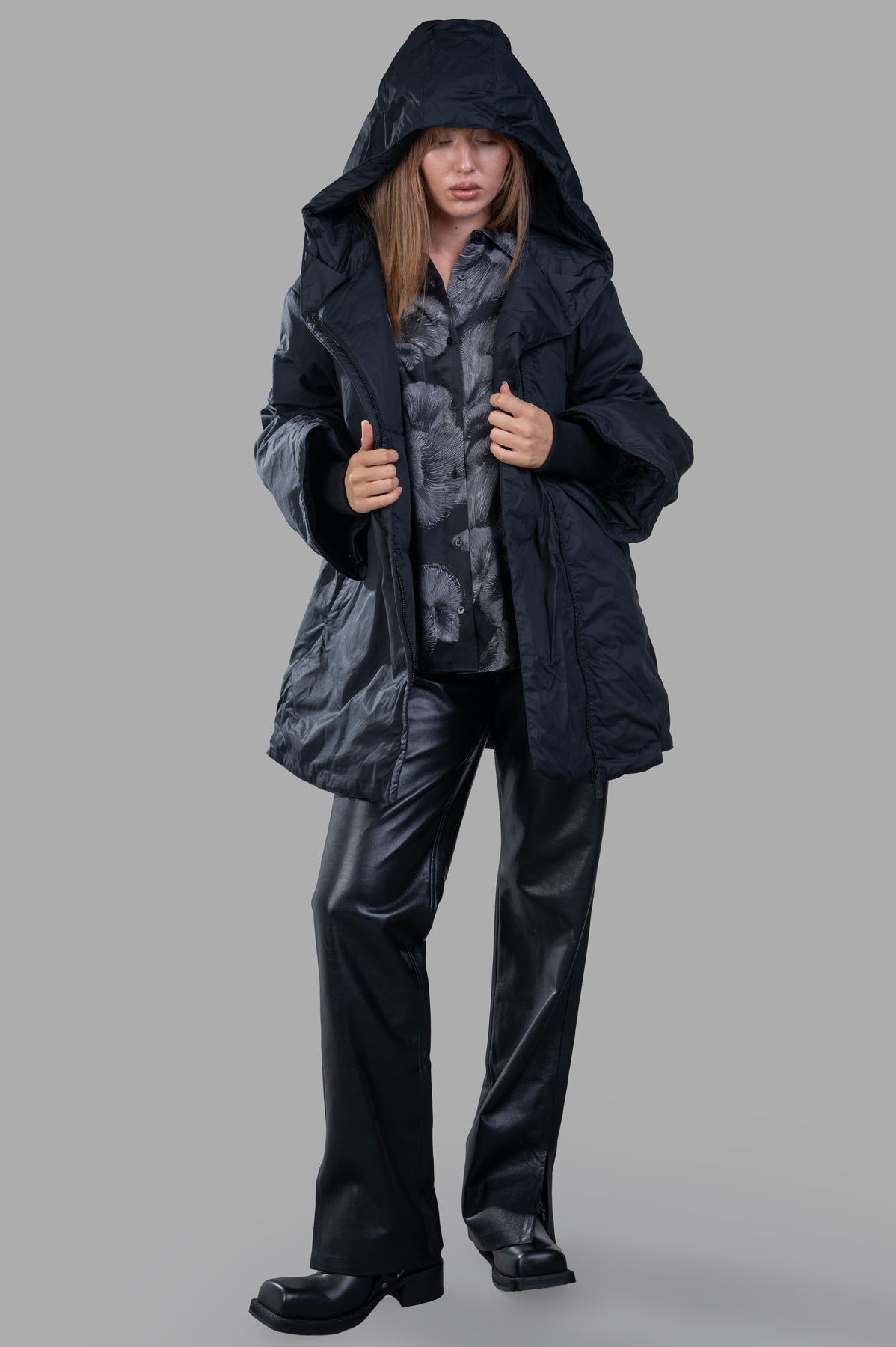 By Malene Birger Sallimo Padded Coat in black, with large hood, worn by model, showing front view and voluminous silhouette.