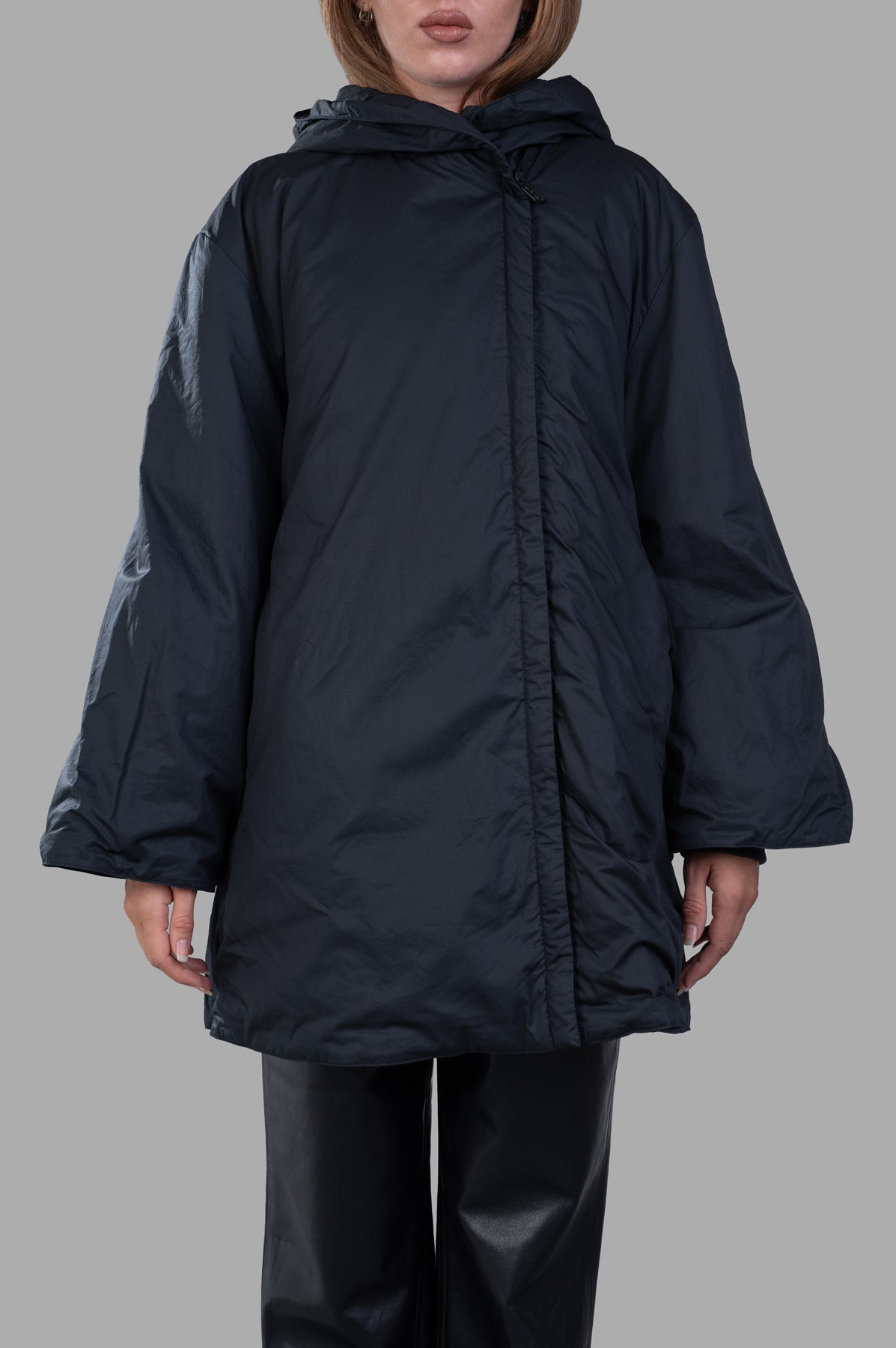 By Malene Birger. Sallimo Padded Coat showcased on model, featuring a voluminous silhouette and large hood in black.