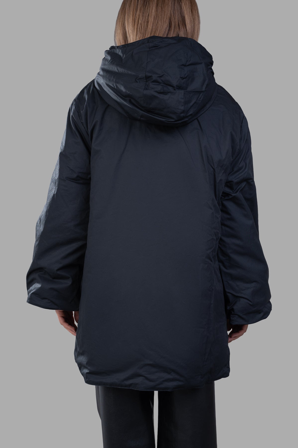 By Malene Birger Sallimo Padded Coat shown from the back, featuring a large adjustable hood in a black padded design.