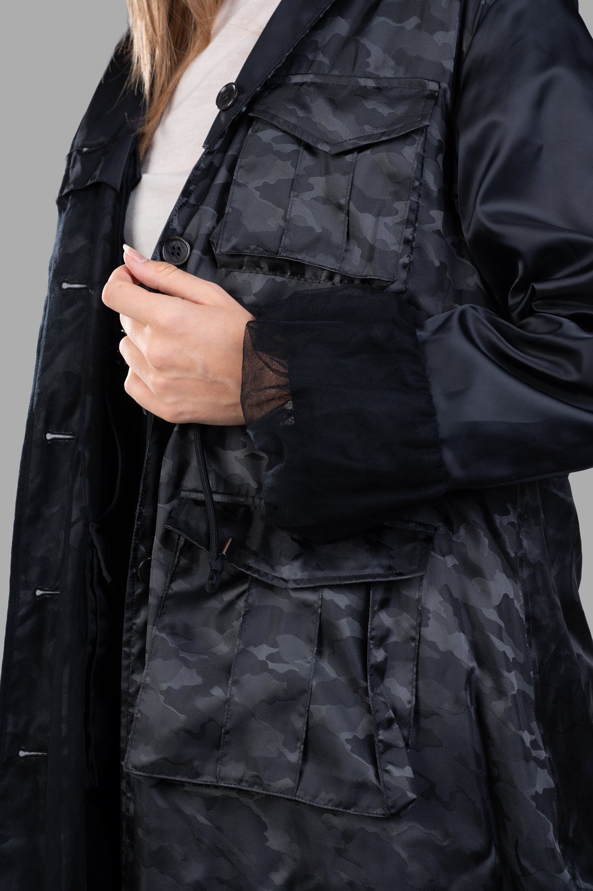 Noir Kei Ninomiya Reversible Trench Coat showcasing detailed button-fastening ruffle cuffs and stylish multi-functional.