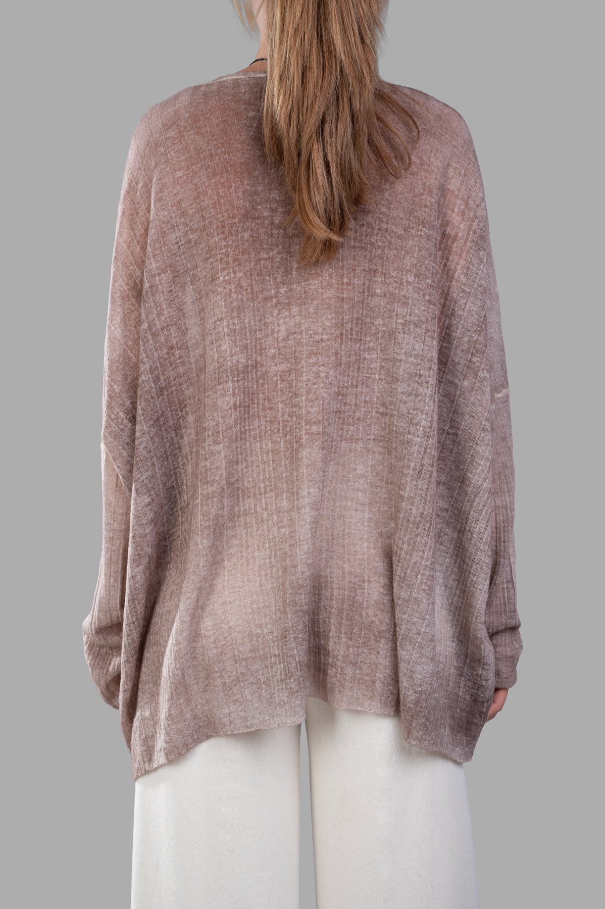 Avant Toi Ribbed Oversized Sweater in beige, showcasing the back with a unique handkerchief hem and soft texture.