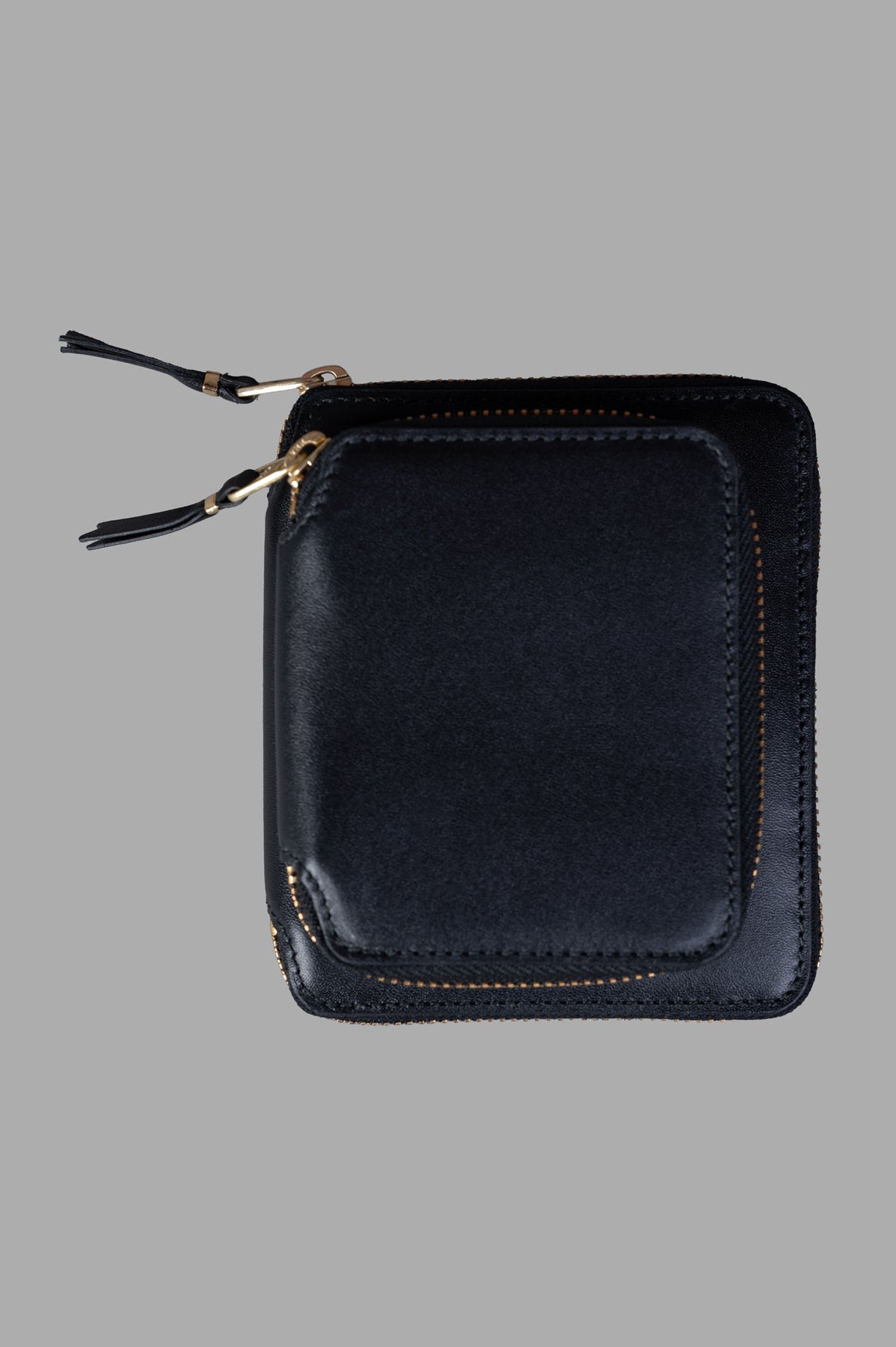 Comme des Garçons Double-Pocket Zip Wallet, black leather, front view with zip details visible.
