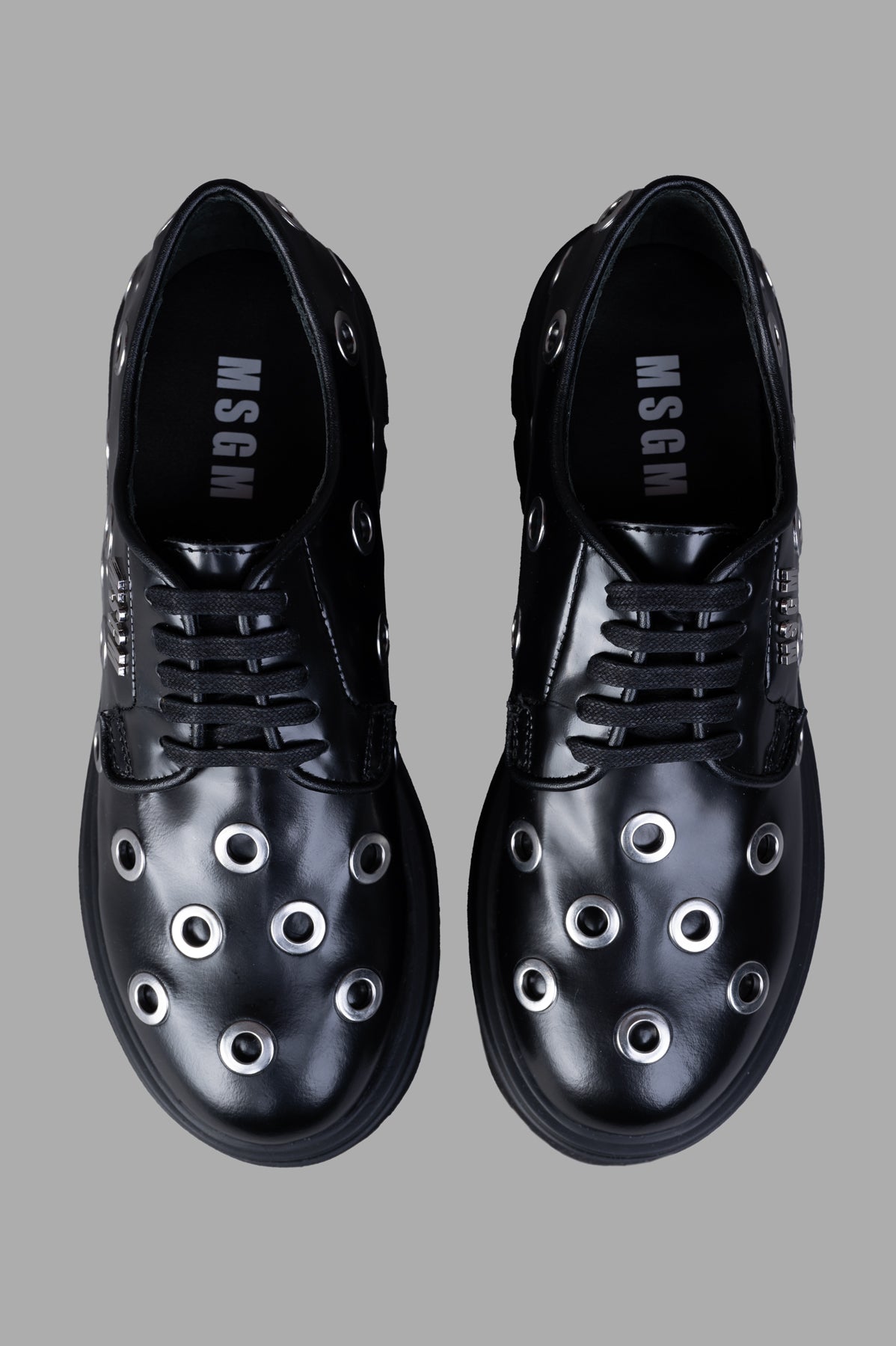 MSGM Studded Oxford Shoes featuring lace-up design and trendy studs, showcasing a sleek black leather upper.