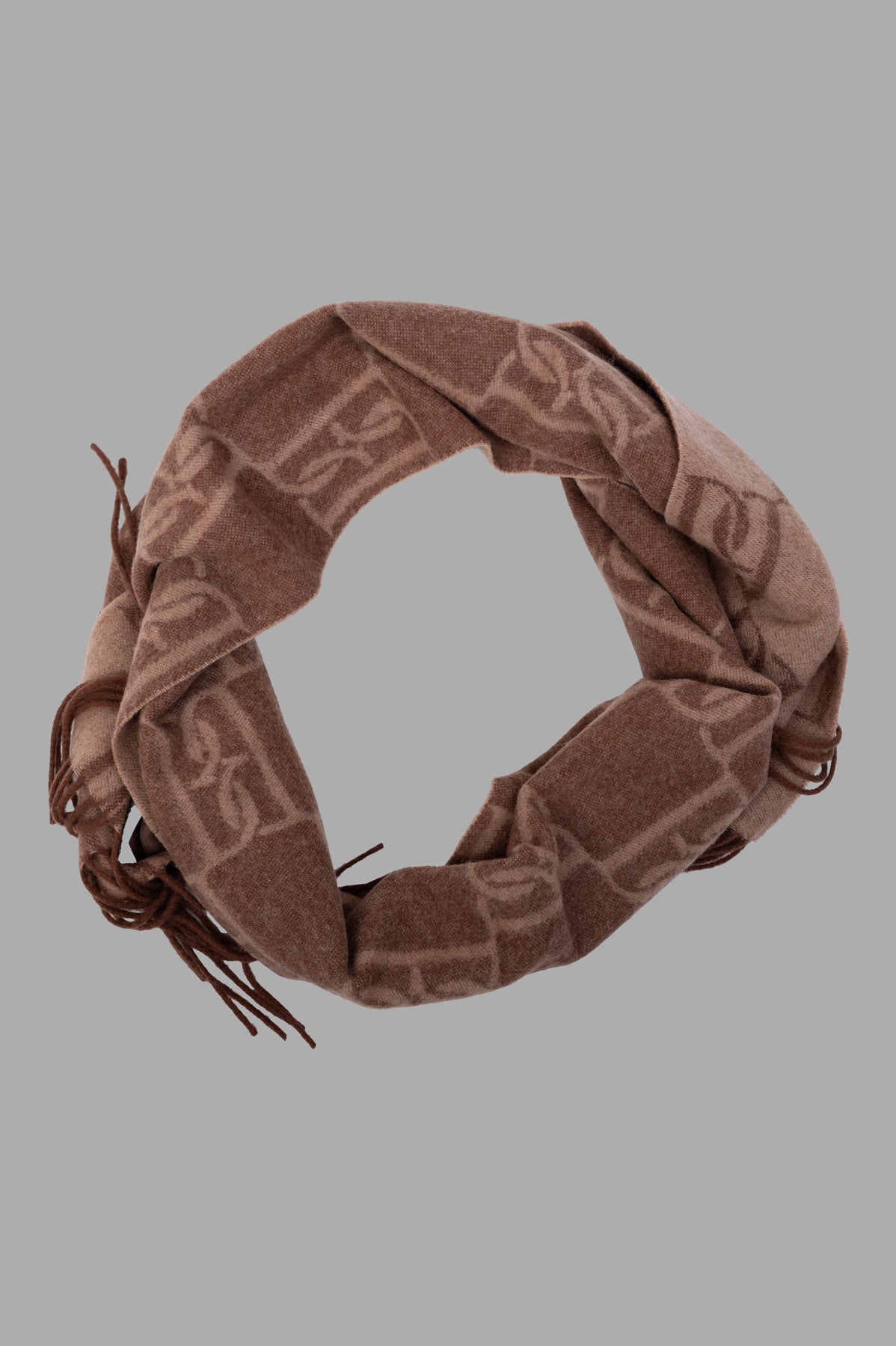By Malene Birger Manno Wool Scarf in brown, showing monogram print, slender shape, and long fringes.