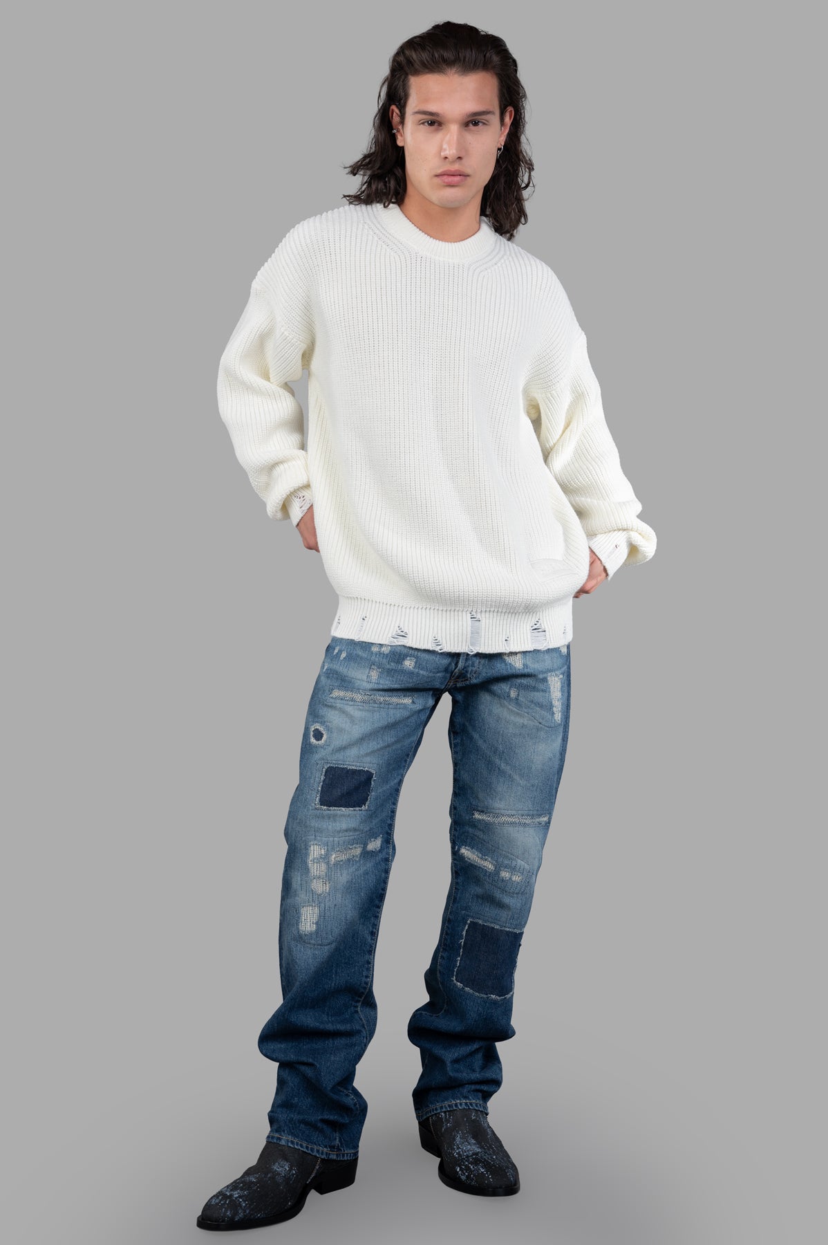 Junya Watanabe Indigo Distressed Jeans modeled front view, featuring patch details and yellow contrast stitching.