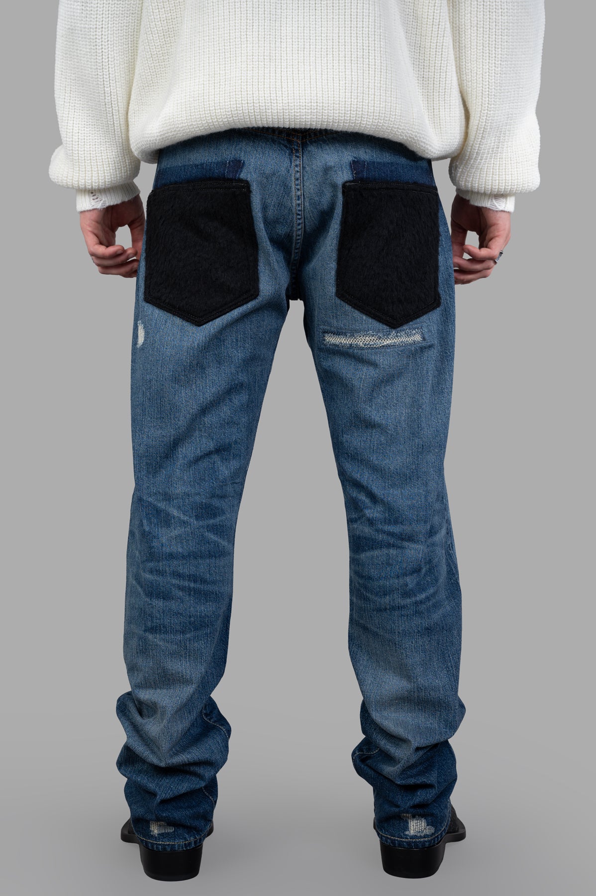 Junya Watanabe Indigo Distressed Jeans featuring unique back pockets and contrast stitching, showcasing a stylish and.