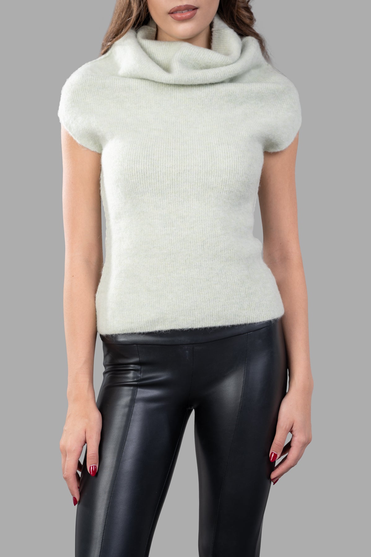Rick Owens Crater Sweater Vest in mint green, showcasing a high cowl neck and ribbed hem, worn on model with sleek pants.