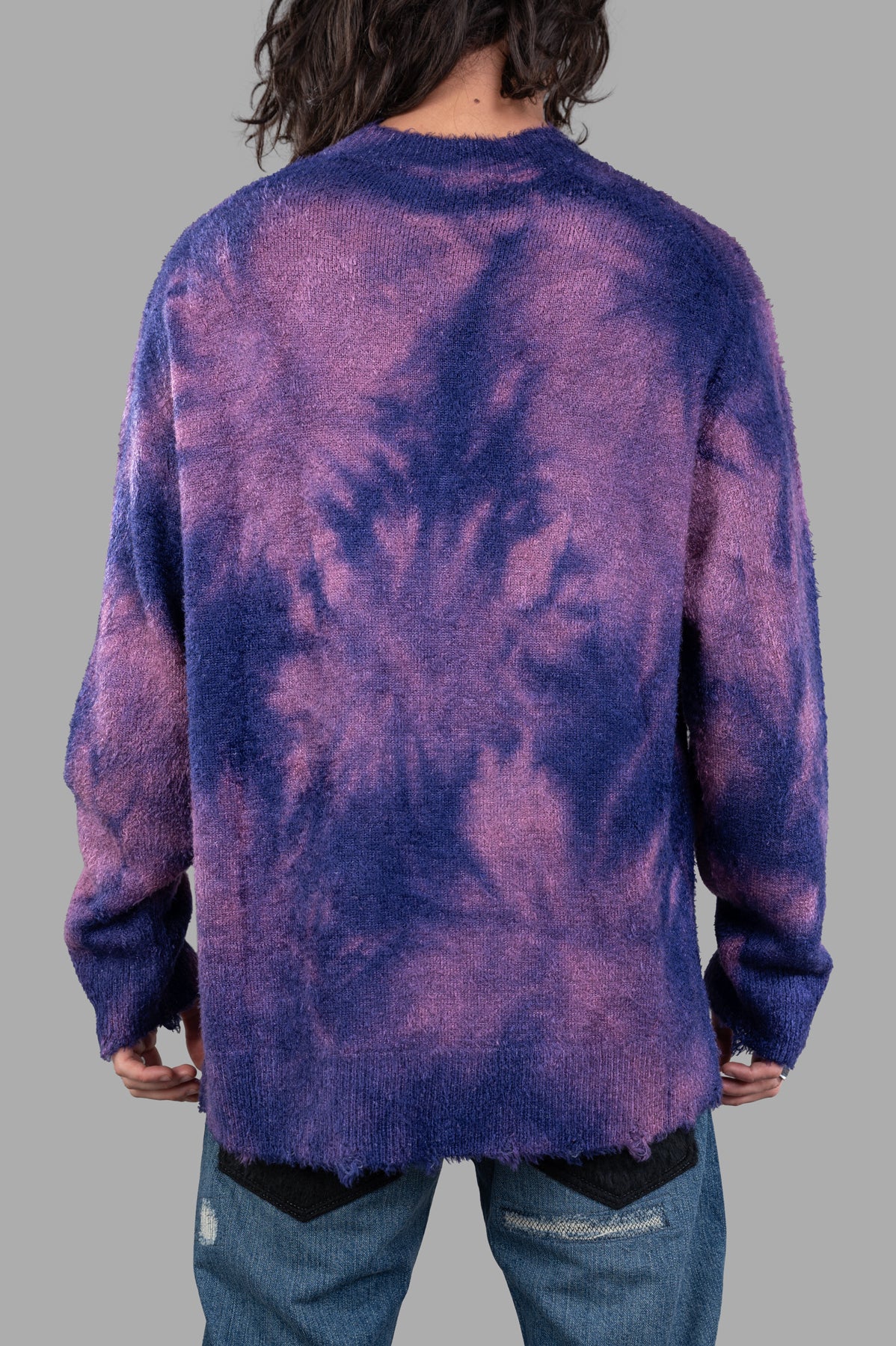 Junya Watanabe Dyed Sweater in blue/pink, showcasing unique uneven dye pattern and textured fabric, viewed from the back.