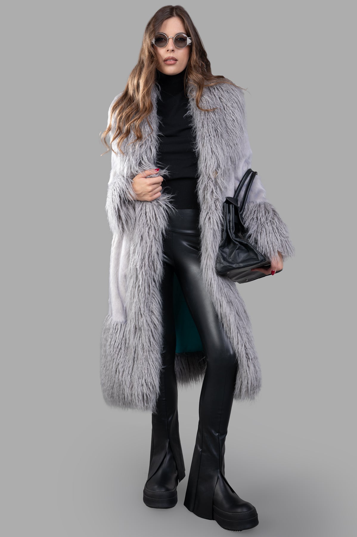 Alabama Muse long-line faux-fur coat in grey, front view on model, animal-free sustainable fashion, textured with frisé fur.