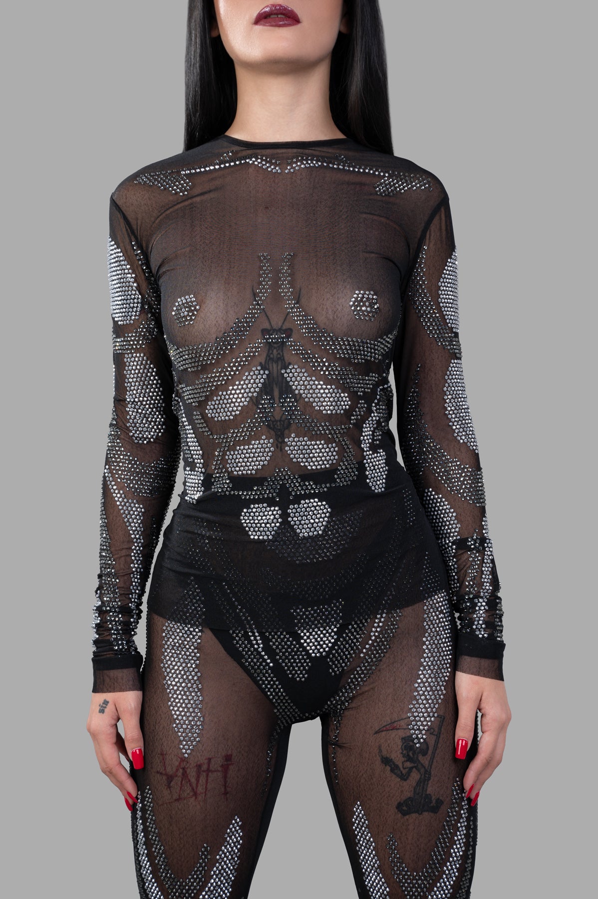 Natasha Zinko Rhinestones Embellished Top featuring a sheer design with intricate rhinestone detailing on long sleeves.