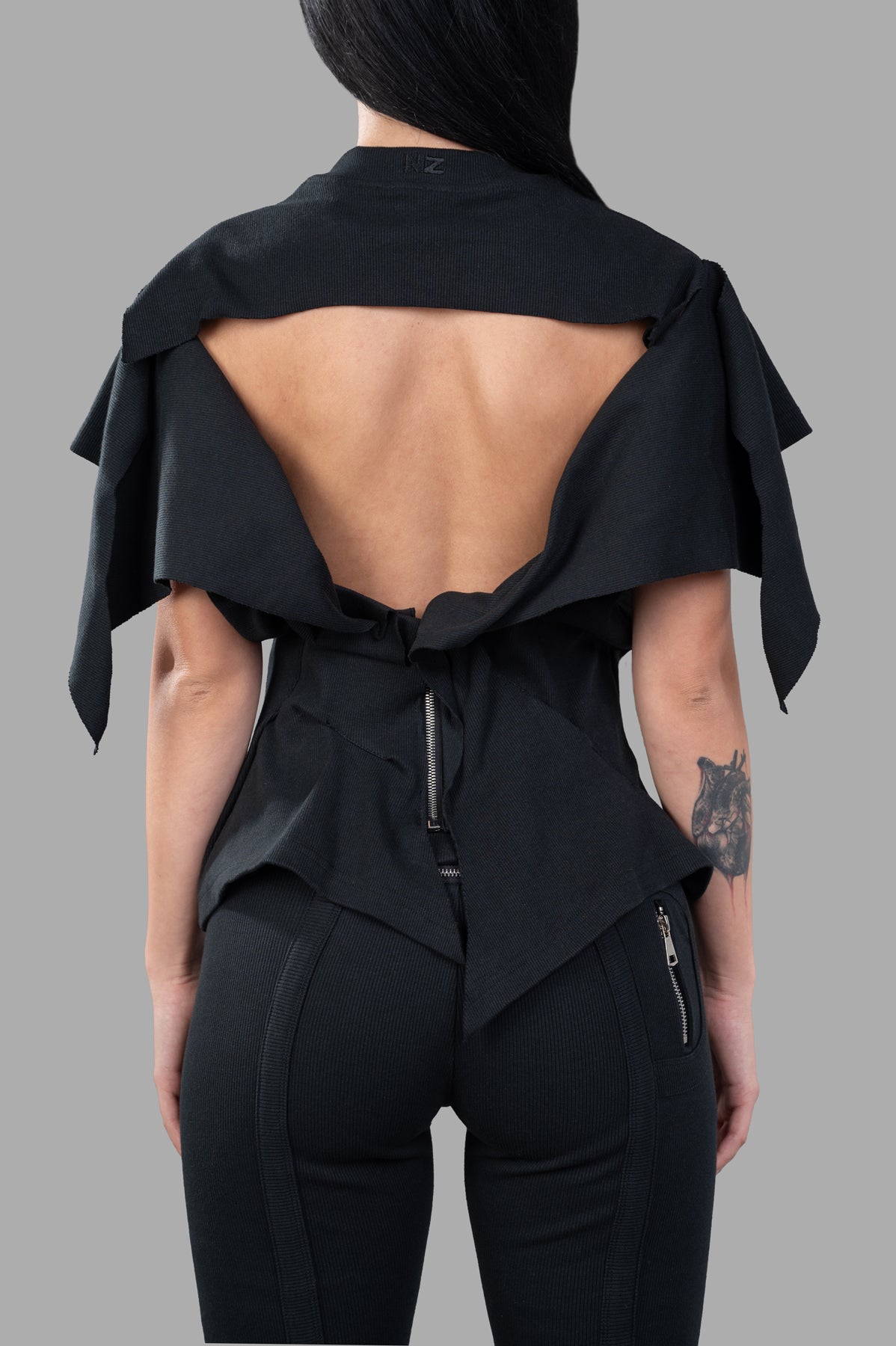 Natasha Zinko Rhinestones Embellished T-shirt showcased from the back, featuring an open design and corseted waist detail.