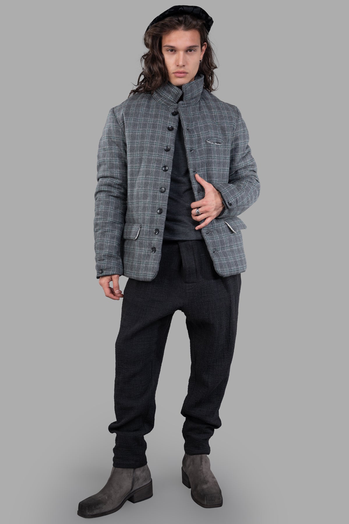 Marc Point grey padded plaid jacket on model, featuring a button-up front, stand collar, and side flap pockets.