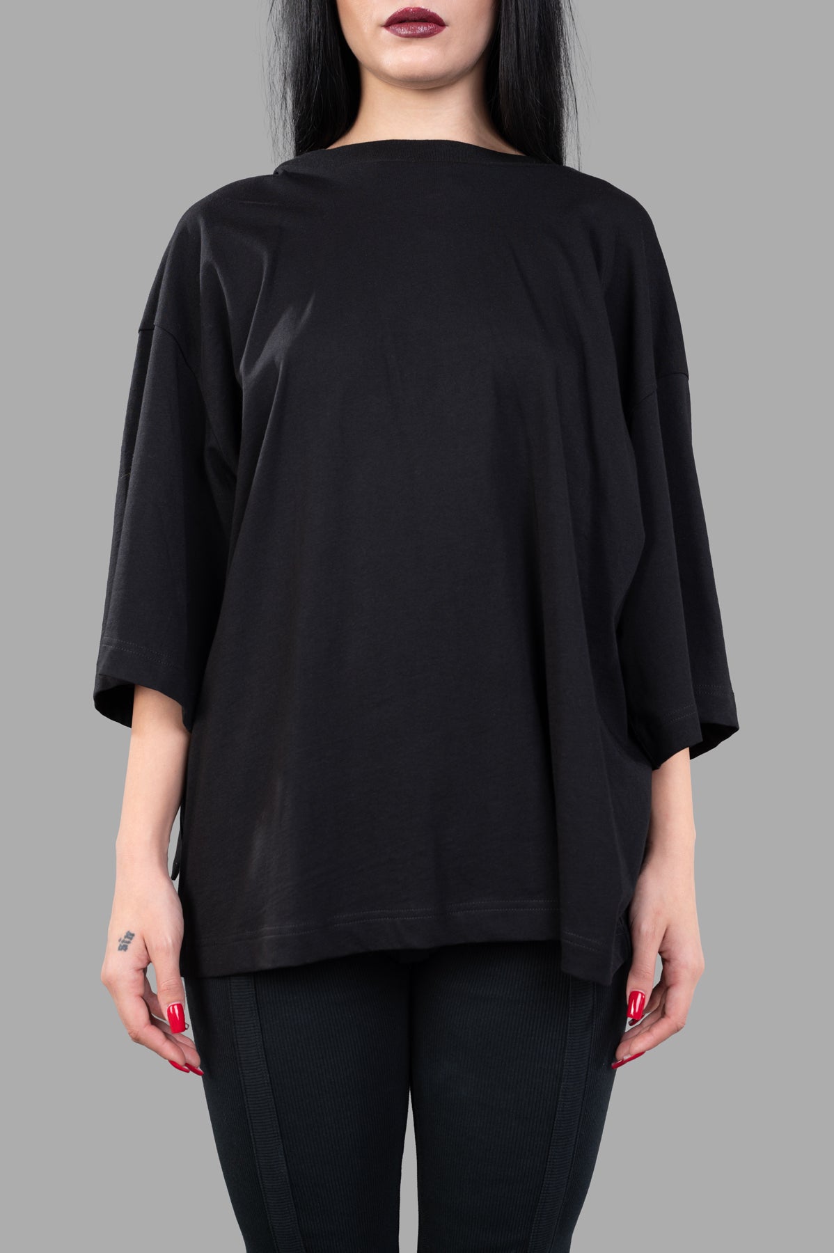 **Alt text:** Natasha Zinko Bandit T-shirt displayed front on model, featuring a relaxed fit and black color.
