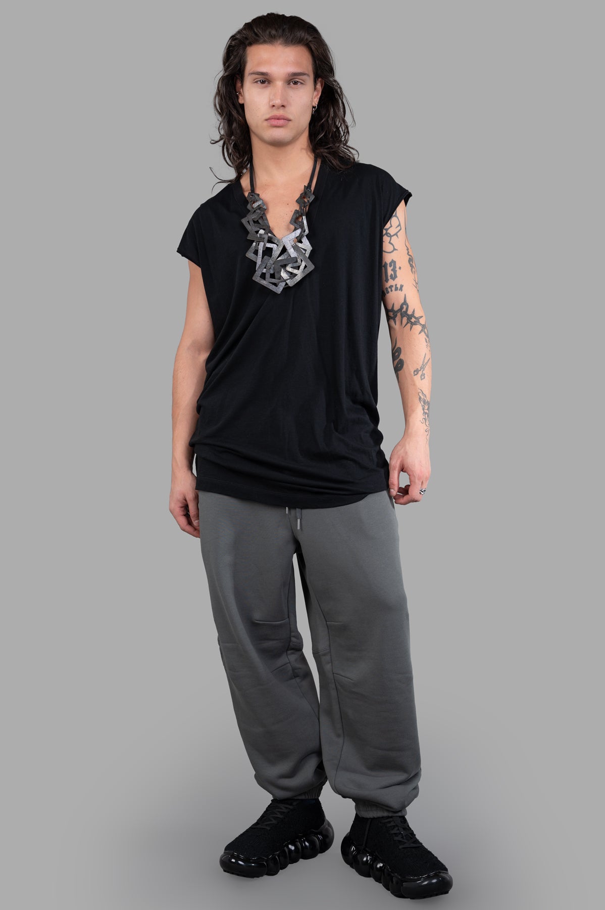 Helmut Lang Curved Sweatpants in grey, on-model front view, showcasing cozy cotton terry and curvy leg design.