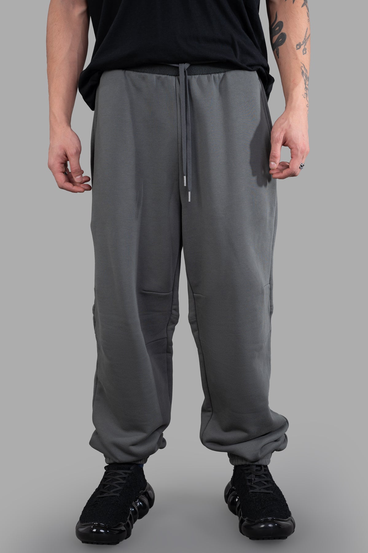 Helmut Lang Curved Sweatpants in grey, showcasing cozy cotton terry with unique seams and patch pockets on a model.