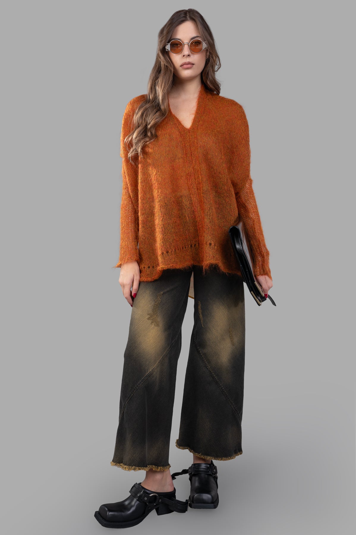 Masnada Mohair Sweater in burnt orange, front view on model, showcasing elongated back and printed trim detail.