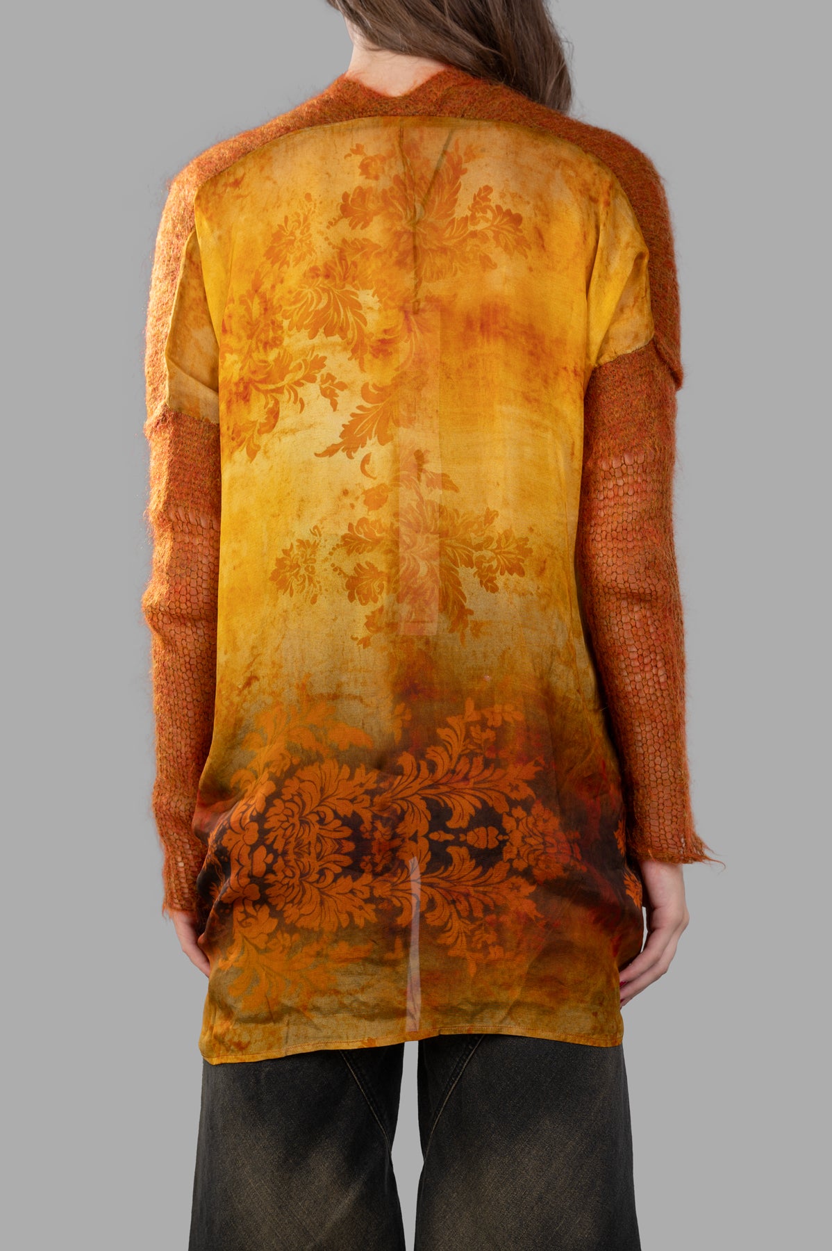 Masnada Mohair Sweater showcasing a vibrant burnt orange back with unique printed design and elongated silhouette, model.