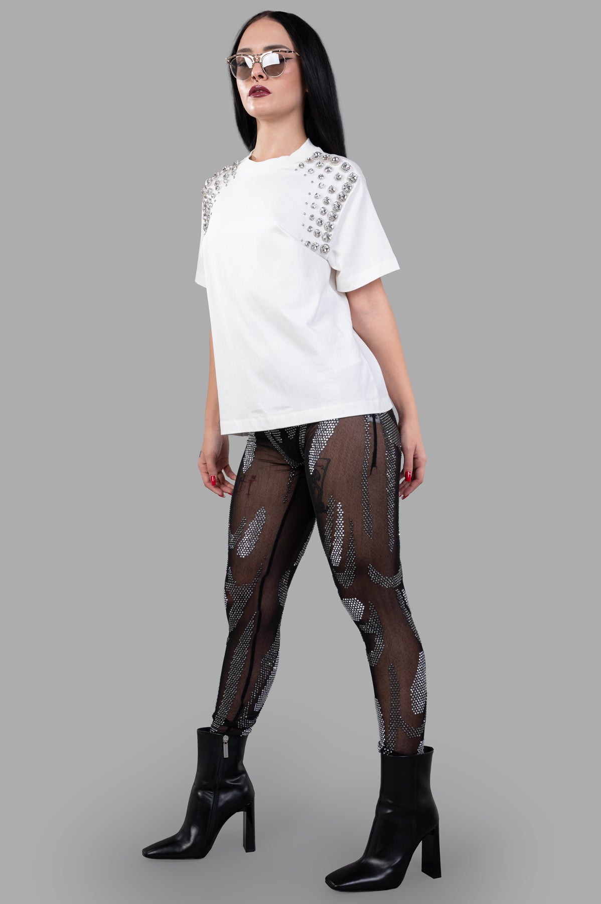 Natasha Zinko Rhinestones Embellished Leggings, front view on model, showcasing see-through black fabric and sparkling.