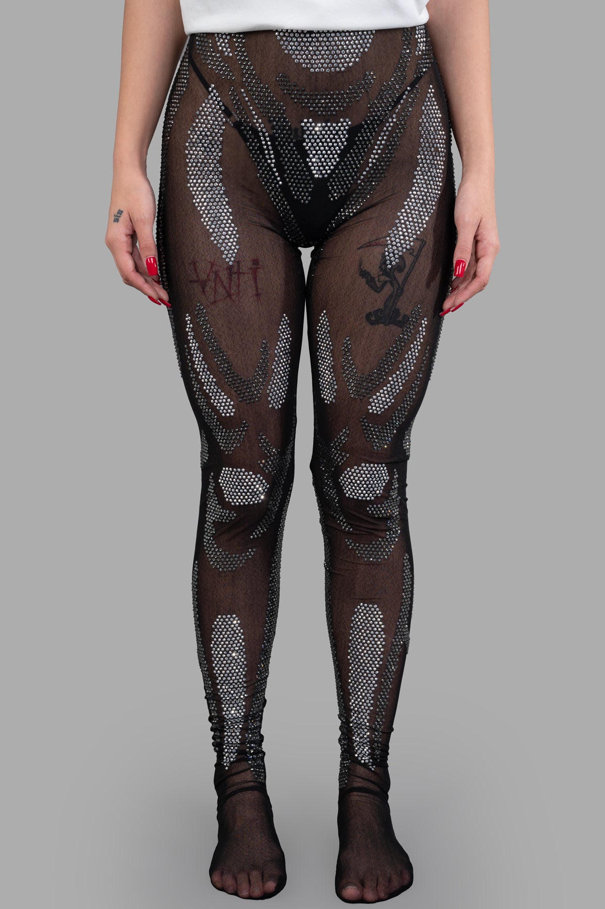 Natasha Zinko. Rhinestones Embellished Leggings featuring a see-through design and sparkling embellishments on model.