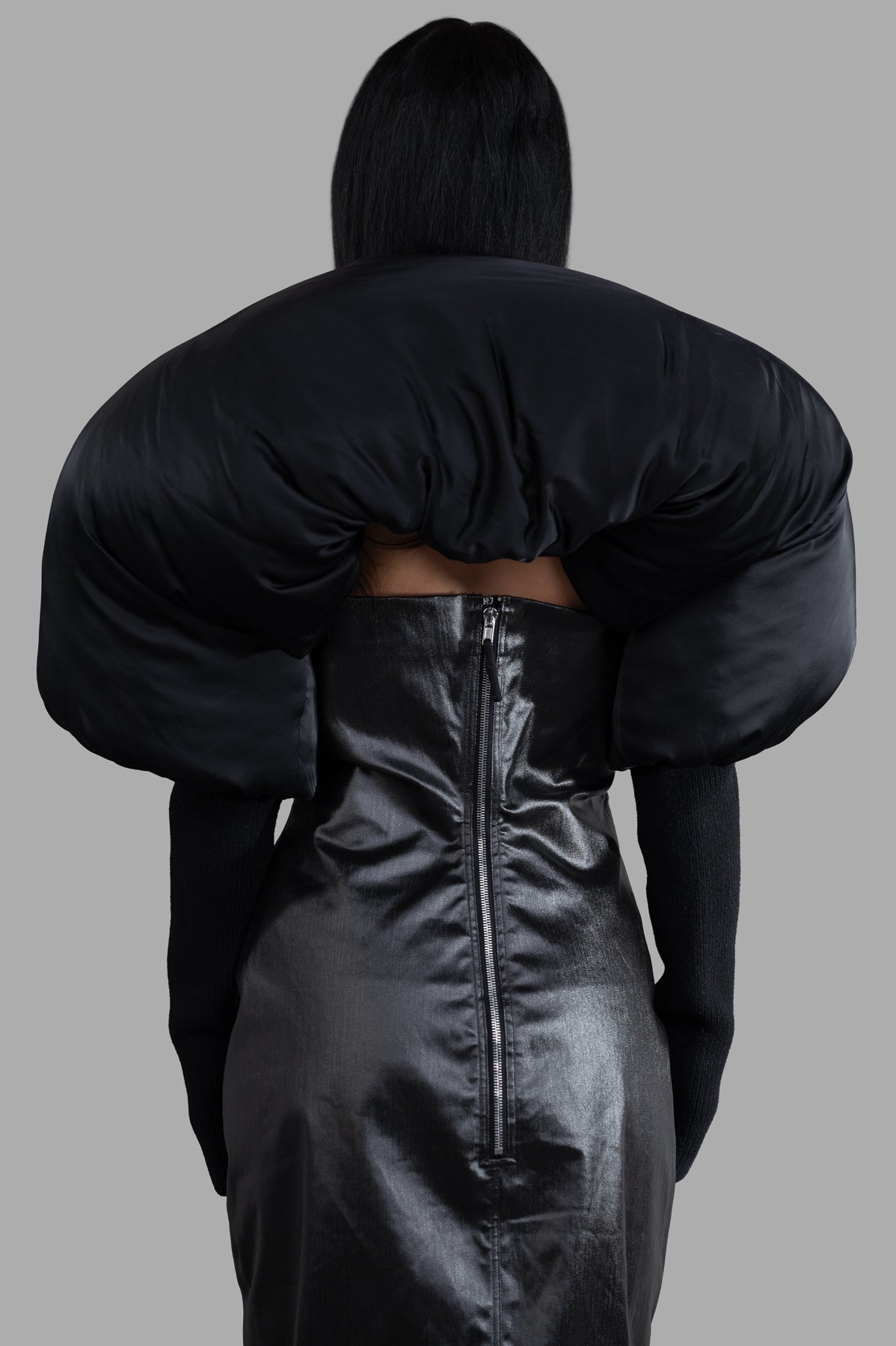 Rick Owens Porterville Runway Duvetina features a dramatic black shroud with ribbed long sleeves, displayed from the back.