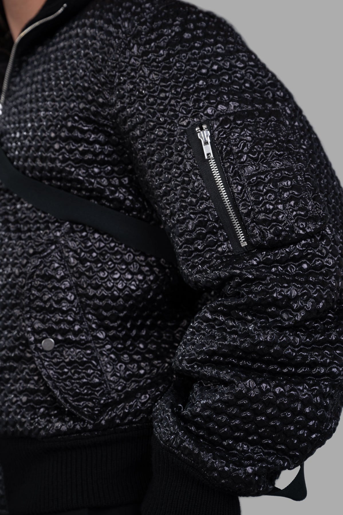 Helmut Lang Seatbelt Bomber jacket showcasing 3D bubblewrap texture and zippered utility pocket, designed for a relaxed fit.