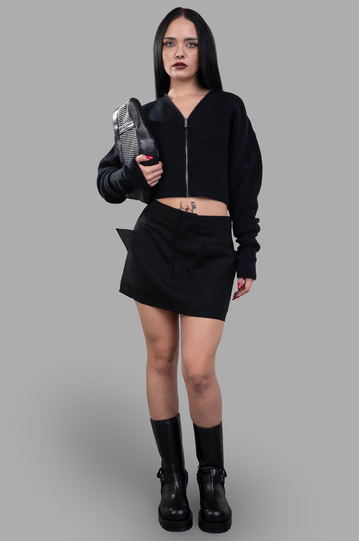 Rick Owens Cut-off Mini Skirt in black wool, front view on model, showcasing tailored waistband and geometric side pockets.