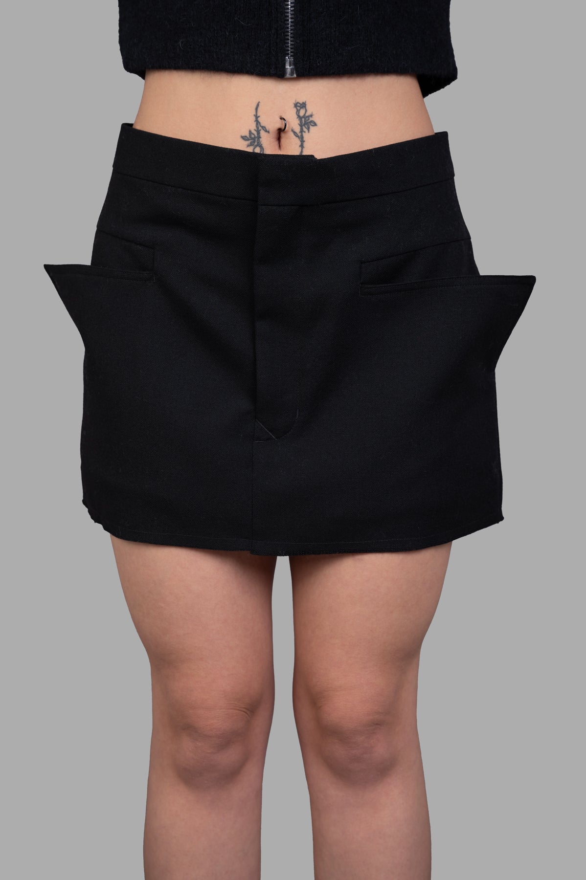 Rick Owens Cut-off Mini Skirt in black, featuring a tailored waistband, front pockets, and high thigh finish on model.