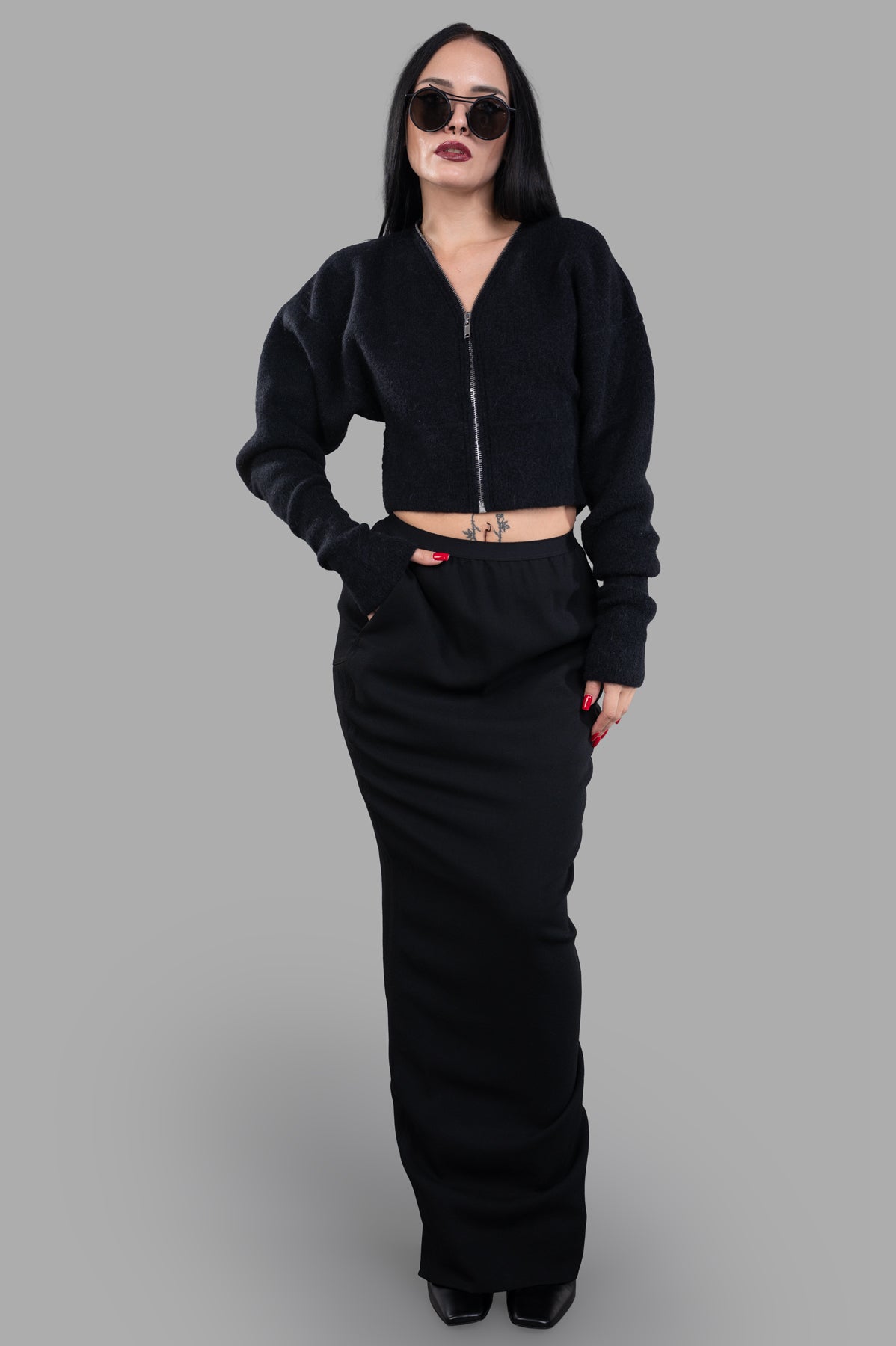 Rick Owens Cropped Cardigan in black with wide shoulders, worn by model, showcasing front zip and batwing sleeves.