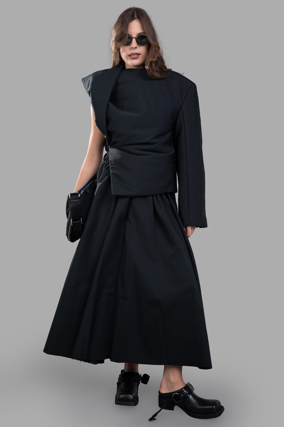 Uma Wang Padded Asymmetric Top in black, half-jacket style, on model. Features cinched waist and luxe design.