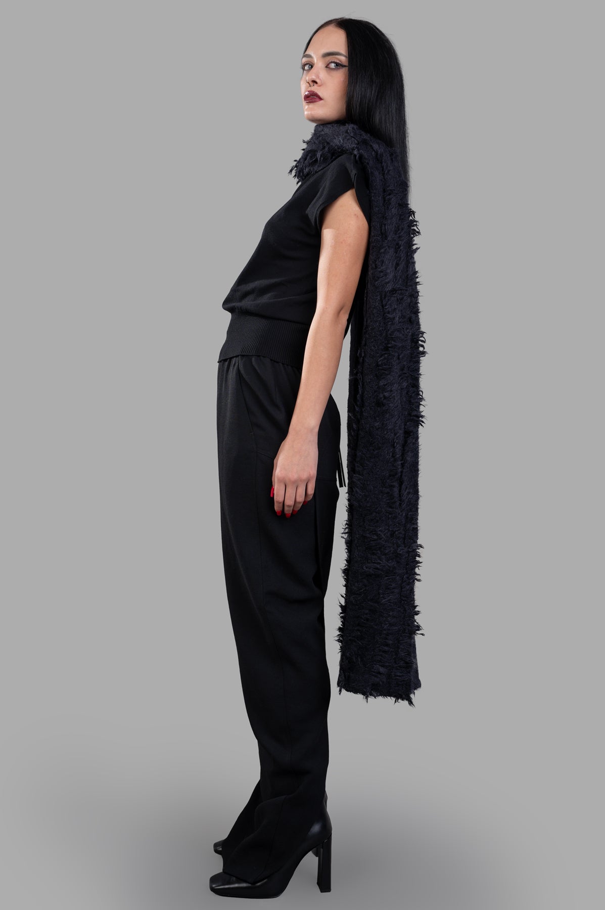 Rick Owens Long Pillar Skirt in black wool, side view on model. Features maxi length, tapered fit, and elastic waistband.