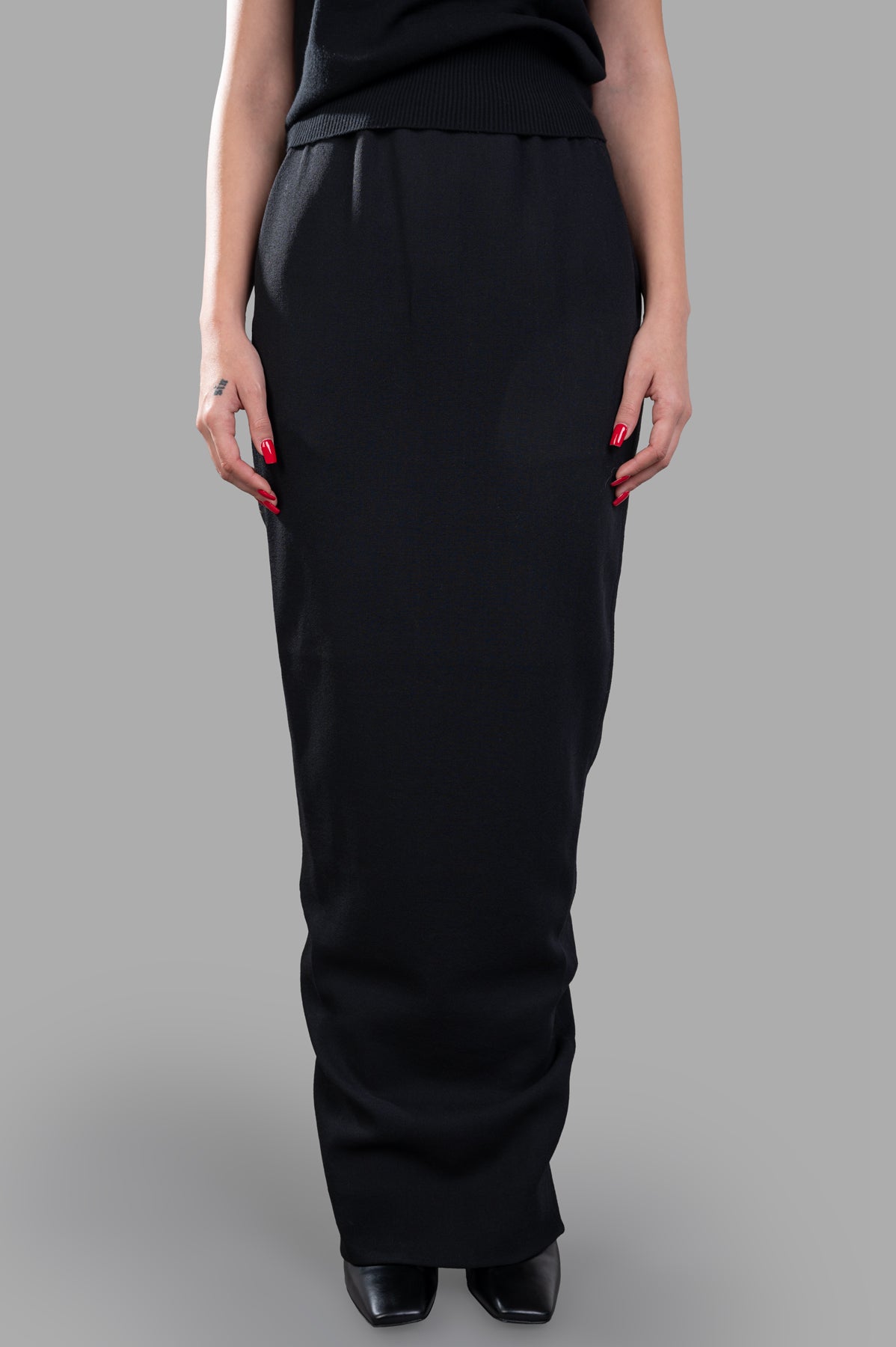Rick Owens Long Pillar Skirt, black wool maxi skirt with elastic waist, fits to ankle, showcasing sleek front design.