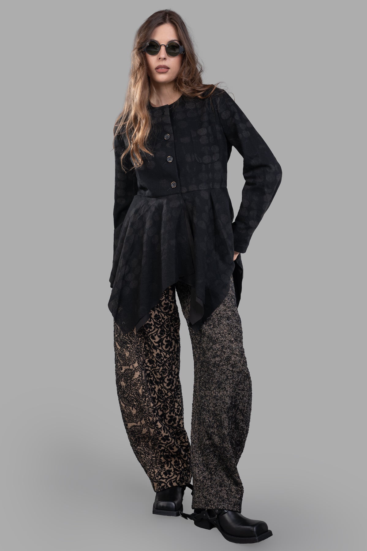 Uma Wang Pleat-detailing Jacket in black wool, front view on model. Flared hem and button fastening add sophistication.