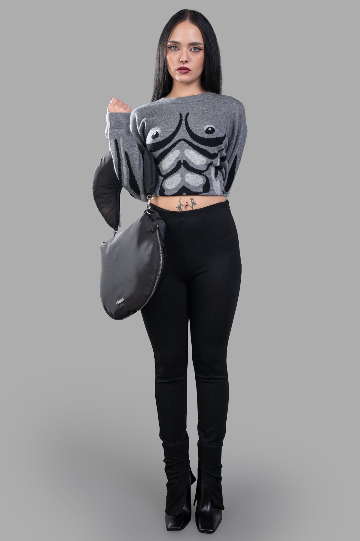 Natasha Zinko grey Muscle Jumper on model. Features a knitted wool-cashmere blend, graphic print, and crew neck design.