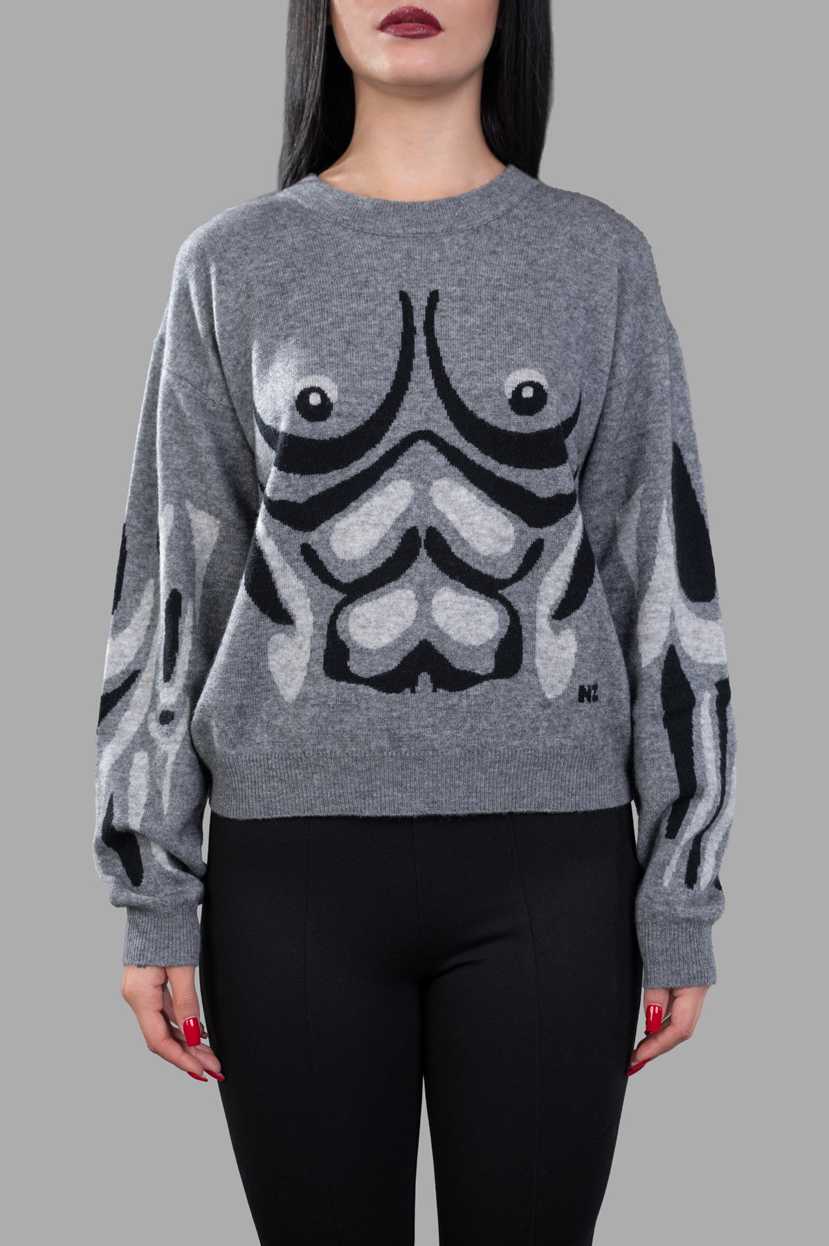 Natasha Zinko Muscle Jumper in grey, featuring a graphic front design, crew neck, and long sleeves on a model.