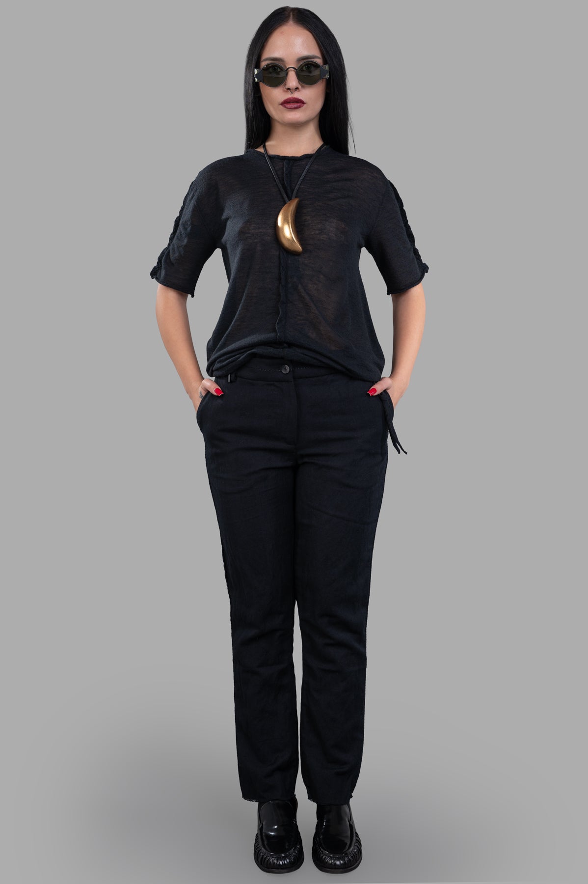 Masnada slim-cut trousers in black, front view on model, featuring a luxurious linen blend with frayed hem detail.