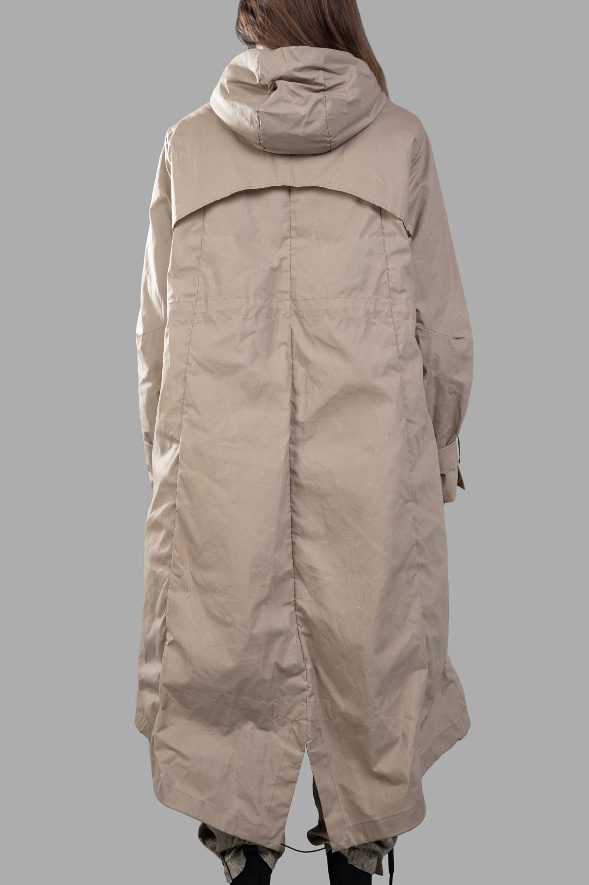 Masnada Layered Raincoat, beige, showcasing the back view with slouchy hood and unique layered design. Crafted with ripstop.